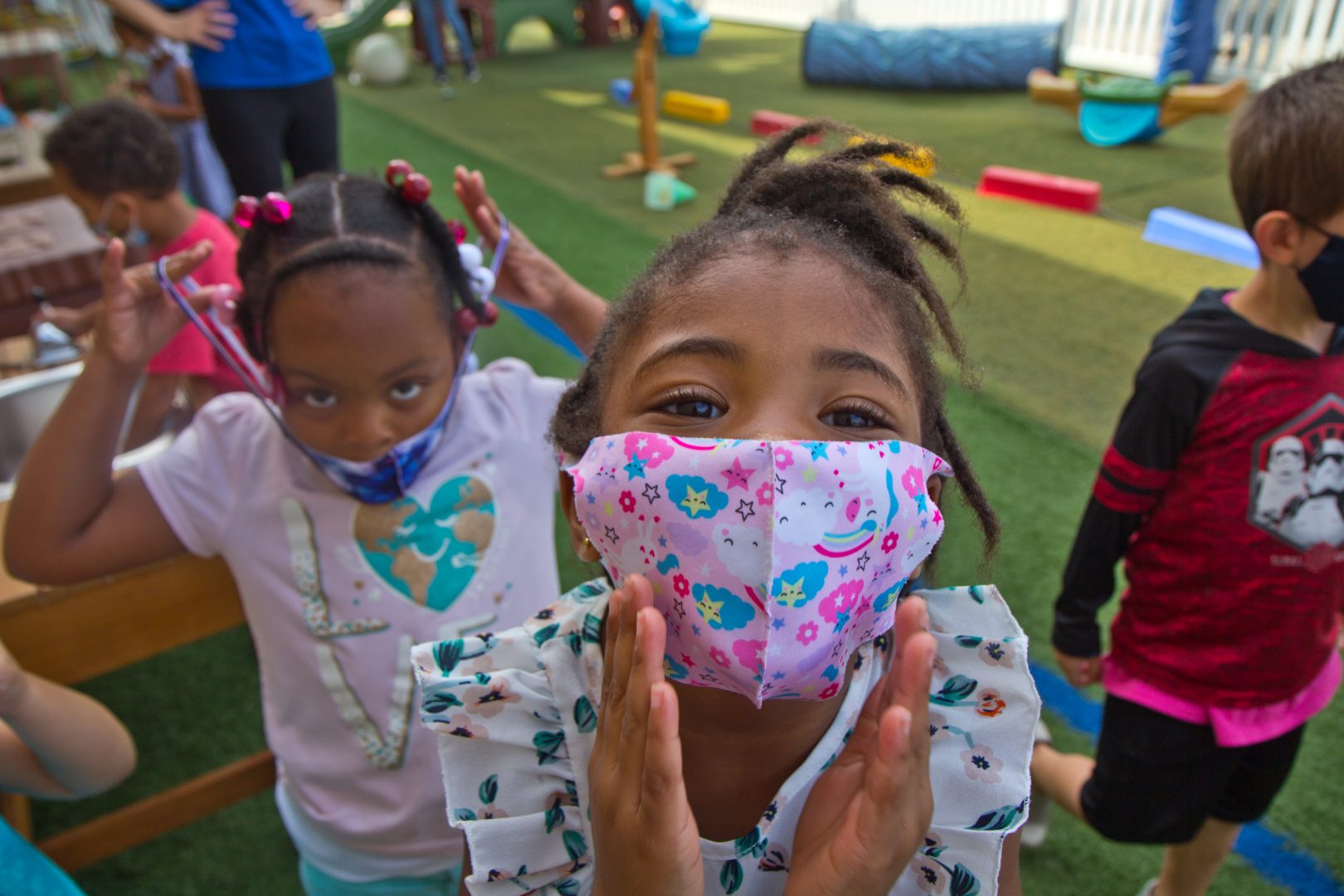 Kids at Today’s Child daycare in Clifton Heights, Pa., are instructed to keep their masks on during outside playtime.