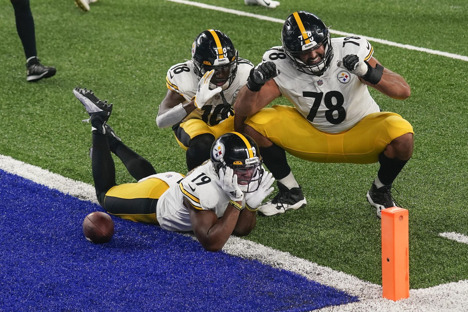 Pittsburgh Steelers wide receiver JuJu Smith-Schuster (19) offensive tackle Alejandro Villanueva (78) and wide receiver Diontae Johnson (18) celebrate after Smith-Schuster scored a touchdown against the New York Giants during the fourth quarter of an NFL football game Monday, Sept. 14, 2020, in East Rutherford, N.J. 