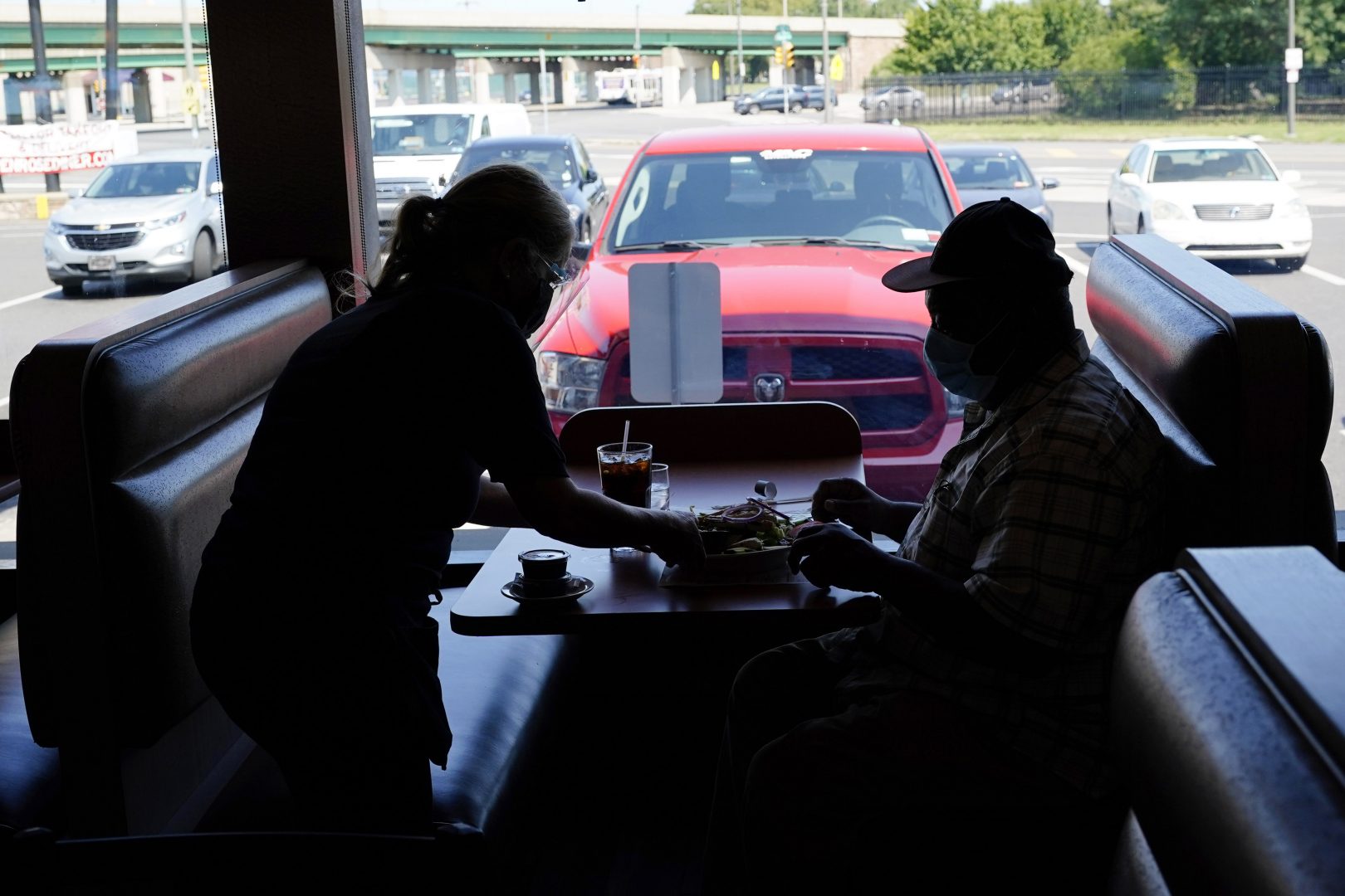 A waitress serves lunch to a customer at the Penrose Diner during the coronavirus pandemic, Tuesday, Sept. 8, 2020, in Philadelphia. 