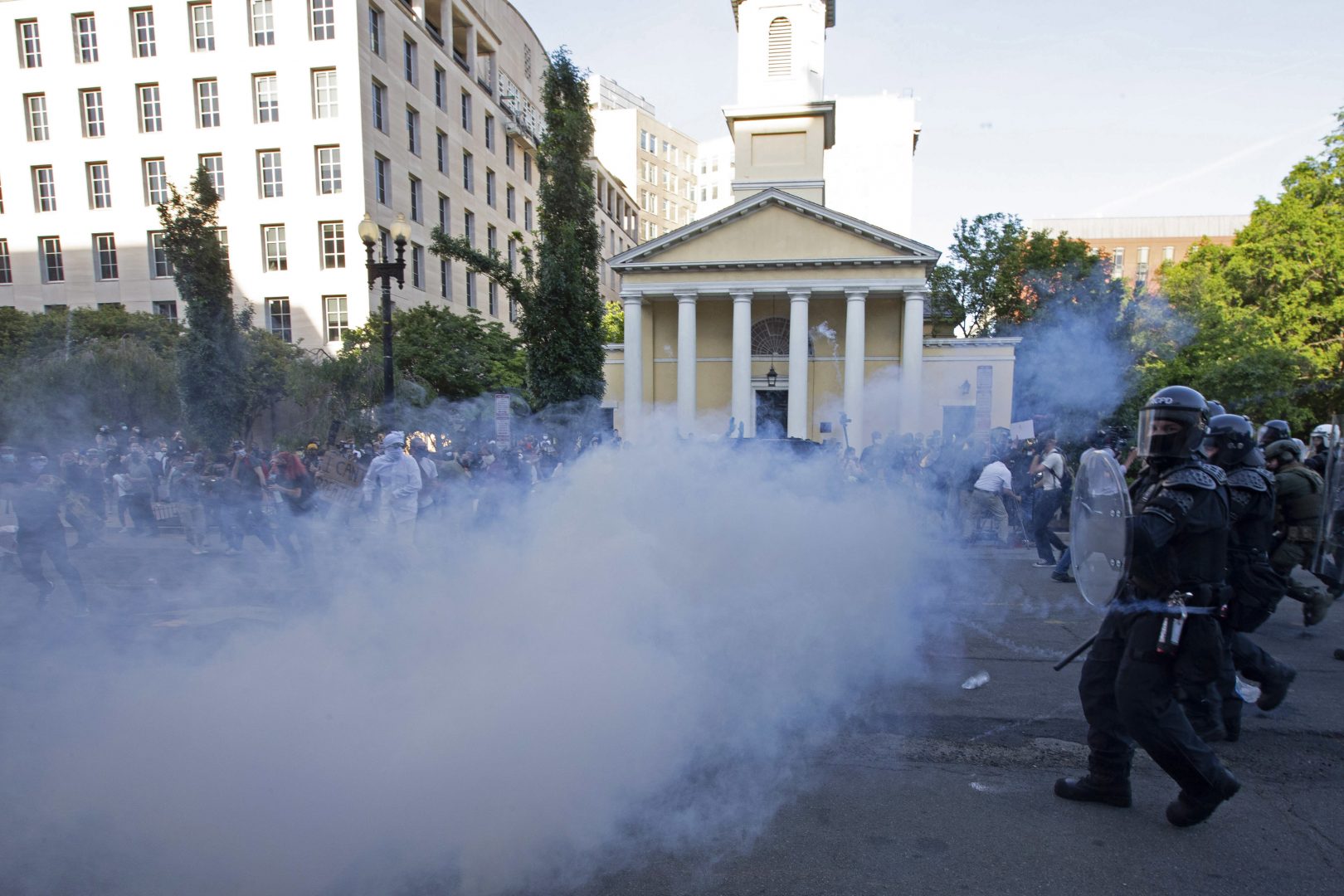 TOPSHOT - Police officers wearing riot gear push back demonstrators shooting tear gas next to St. John's Episcopal Church  outside of the White House, June 1, 2020 in Washington D.C., during a protest over the death of George Floyd. - President Trump visited the church while demonstrators where protesting. With the Trump administration branding instigators of six nights of rioting as domestic terrorists, there were more confrontations between protestors and police and fresh outbreaks of looting. Local US leaders appealed to citizens to give constructive outlet to their rage over the death of an unarmed black man in Minneapolis, while night-time curfews were imposed in cities including Washington, Los Angeles and Houston. (Photo by Jose Luis Magana / AFP) (Photo by JOSE LUIS MAGANA/AFP via Getty Images)