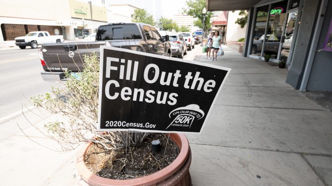 A sign promoting the 2020 census stands in a planter in Roswell, N.M., in August. A federal judge has ordered the Trump administration to continue holding off on wrapping up the census for now.