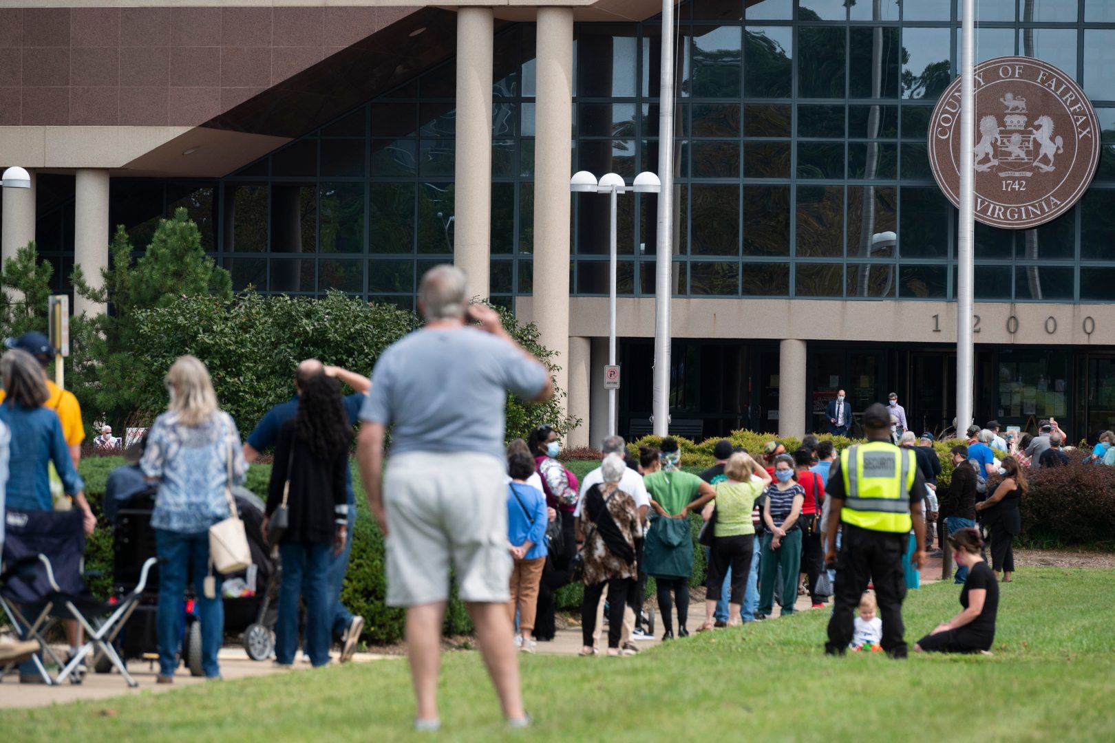 Voters wait in line to cast their ballot at an early voting location in Fairfax, Virginia on September 18, 2020. Growing tensions in the country have some election officials worried about potential violence at polling places.