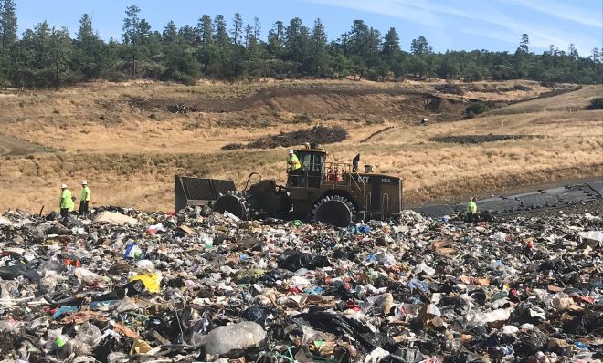 Landfill workers bury all plastic except soda bottles and milk jugs at Rogue Disposal & Recycling in southern Oregon.