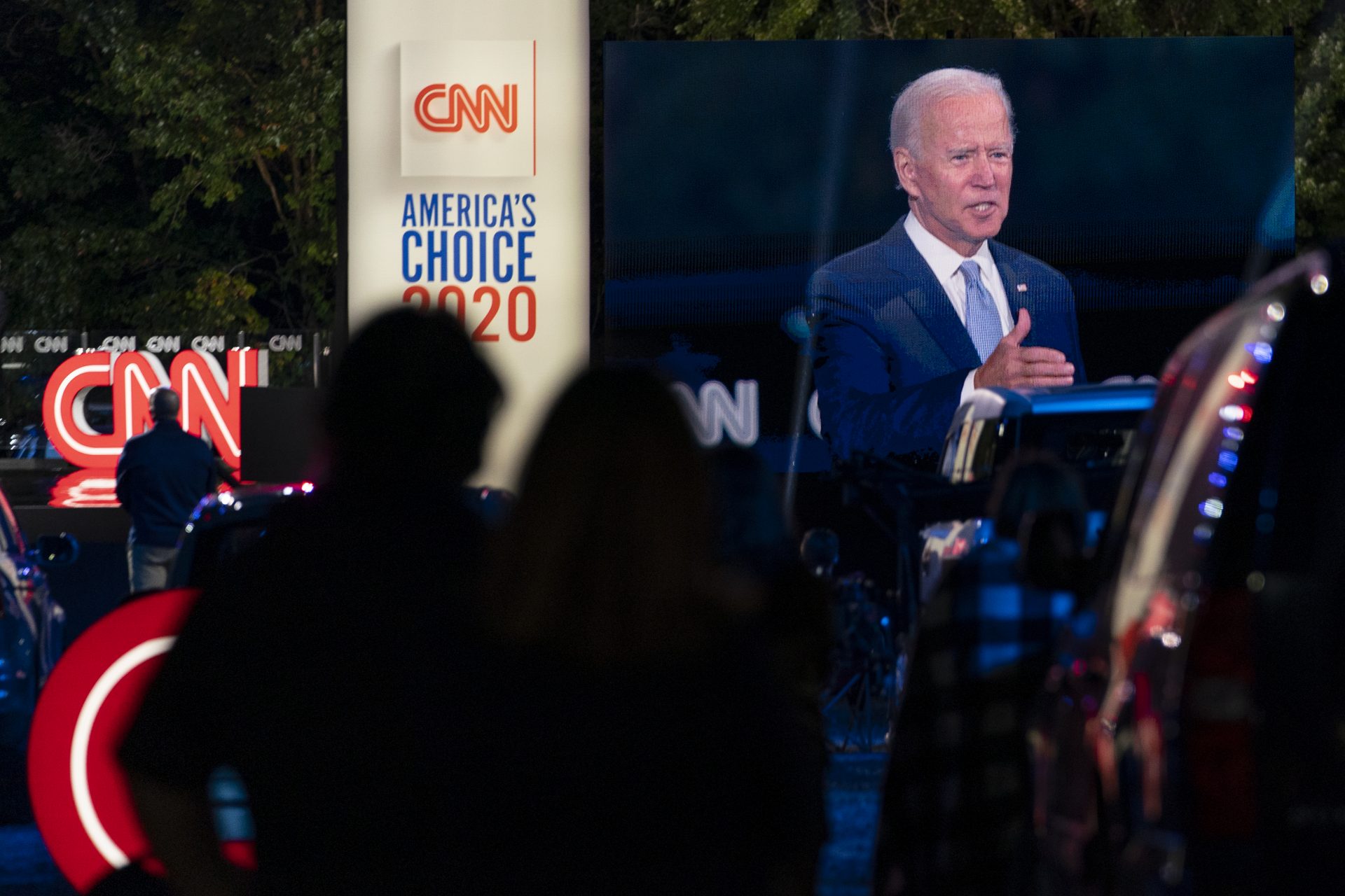 Audience members watch from their cars as Democratic presidential candidate former Vice President Joe Biden, seen on a monitor, speaks during a CNN town hall in Moosic, Pa., Thursday, Sept. 17, 2020.