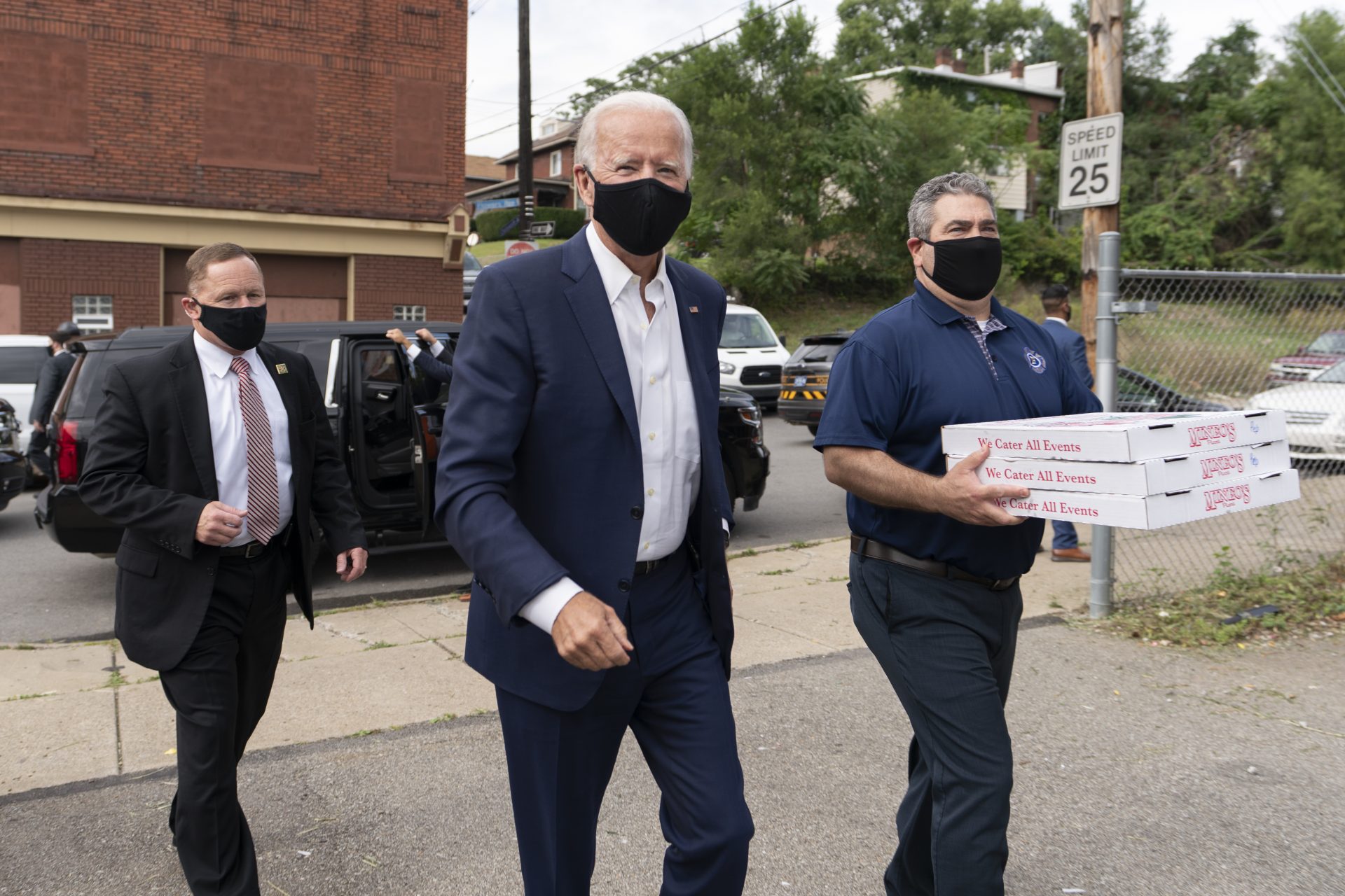 Democratic presidential candidate former Vice President Joe Biden arrises with pizza as he visits Pittsburgh Local Fire Fighters No. 1 in Pittsburgh, Pa., Monday, Aug. 31, 2020.