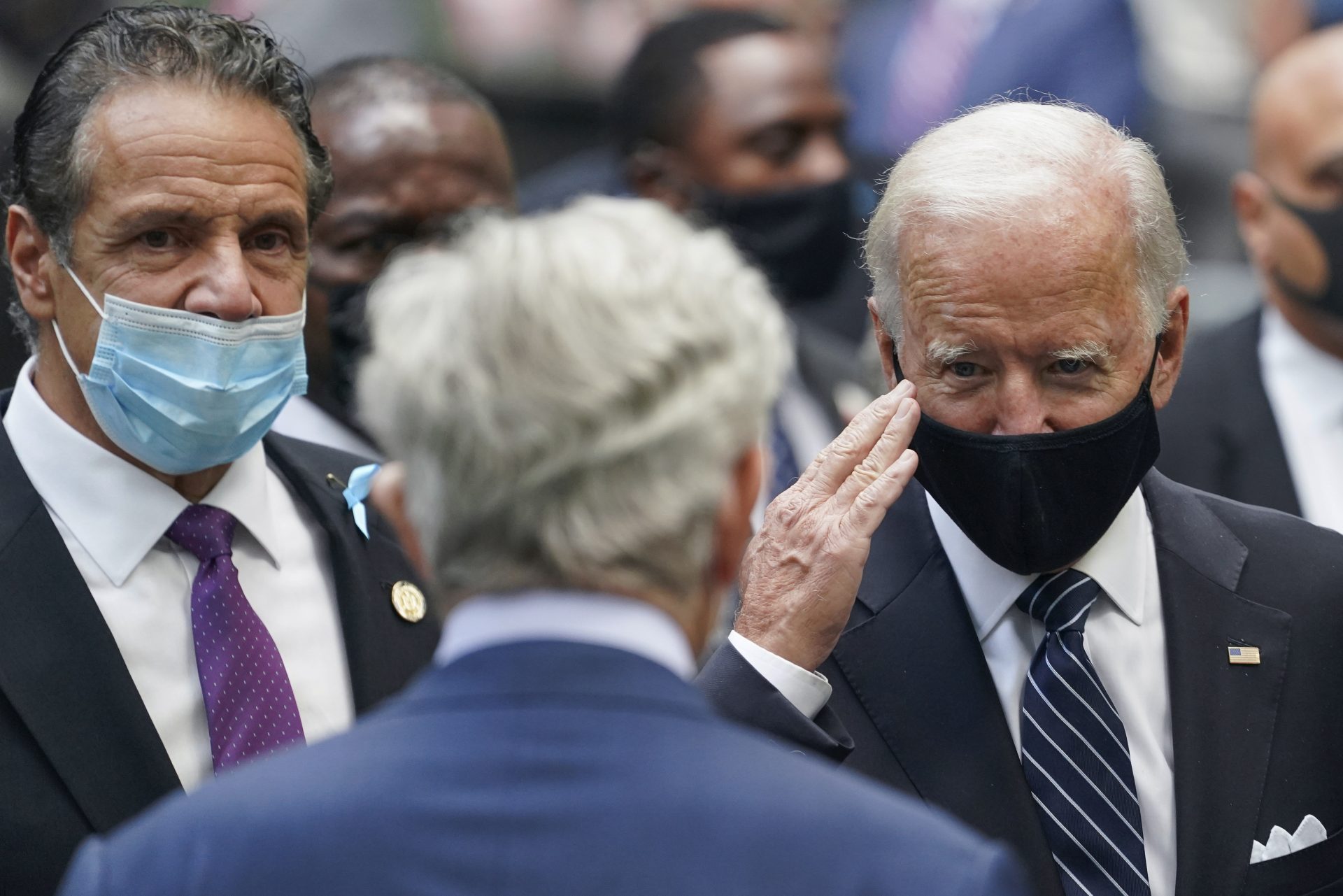 Democratic presidential candidate and former Vice President Joe Biden, salutes a guest alongside New York Gov. Andrew Cuomo, left, at the National September 11 Memorial and Museum, Friday, Sept. 11, 2020, in New York. Americans will commemorate 9/11 with tributes that have been altered by coronavirus precautions and woven into the presidential campaign.