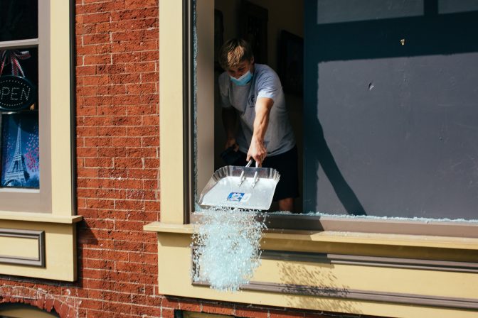 Lancaster City Investment District employees, business owners and residents work to clean and repair the destruction following a night of protests in Lancaster, Pa., on September 14, 2020.
