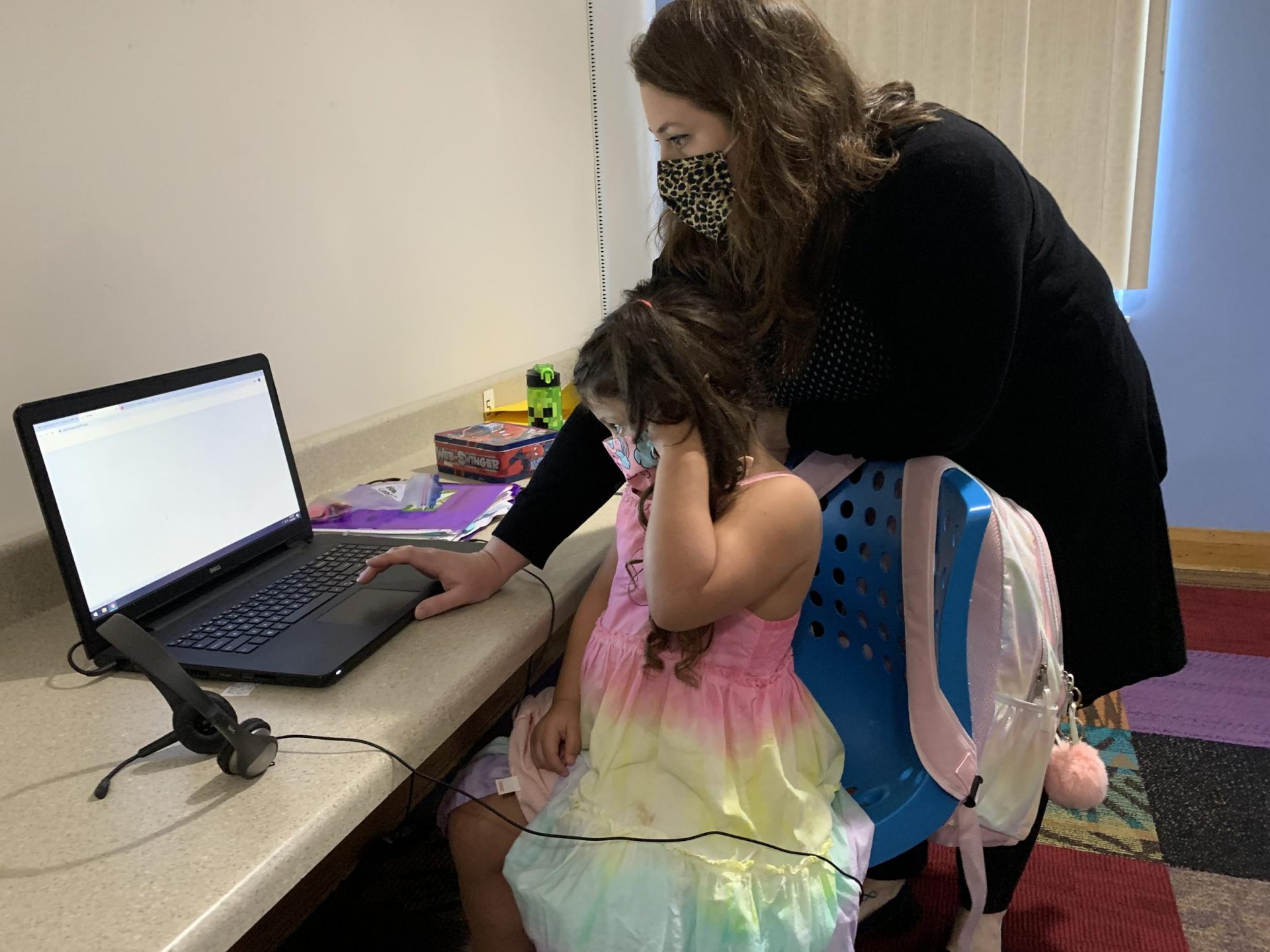 Colleen Vilsack, left, helps a student during virtual learning at the Millvale Boys and Girls Club.