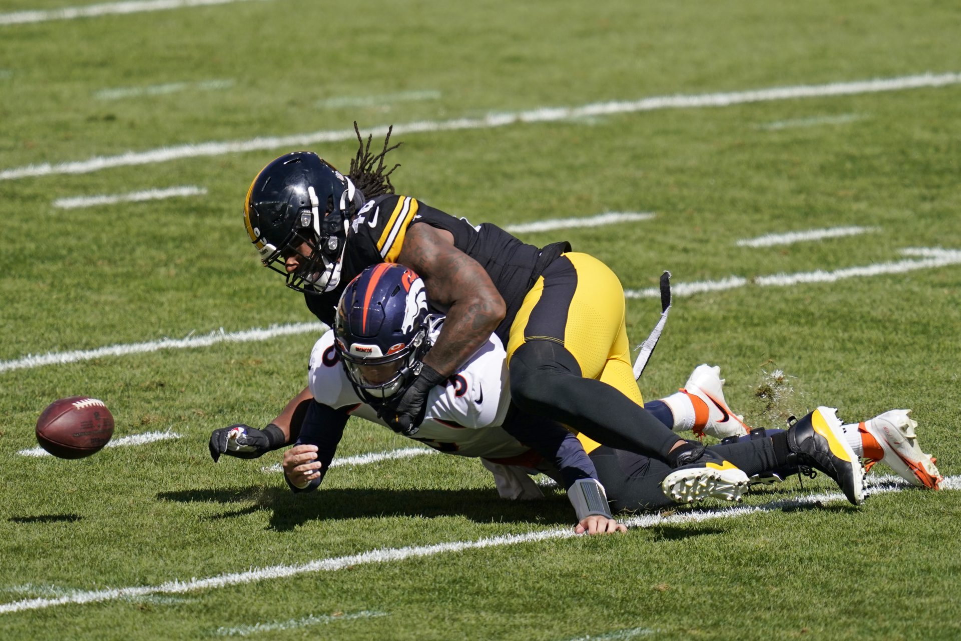 Pittsburgh Steelers outside linebacker Bud Dupree (48) forces a fumble by Denver Broncos quarterback Drew Lock (3) during the first half of an NFL football game, Sunday, Sept. 20, 2020, in Pittsburgh. The Steelers recovered the fumble and Lock was injured on the play.
