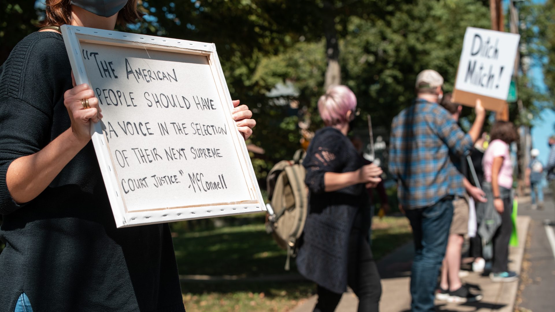 Protesters rally in front of Senate Majority Leader Mitch McConnell's home in Louisville, Ky., on Sunday. Soon after Justice Ruth Bader Ginsburg's death, McConnell said President Trump's court nominee will receive a vote in the Senate.