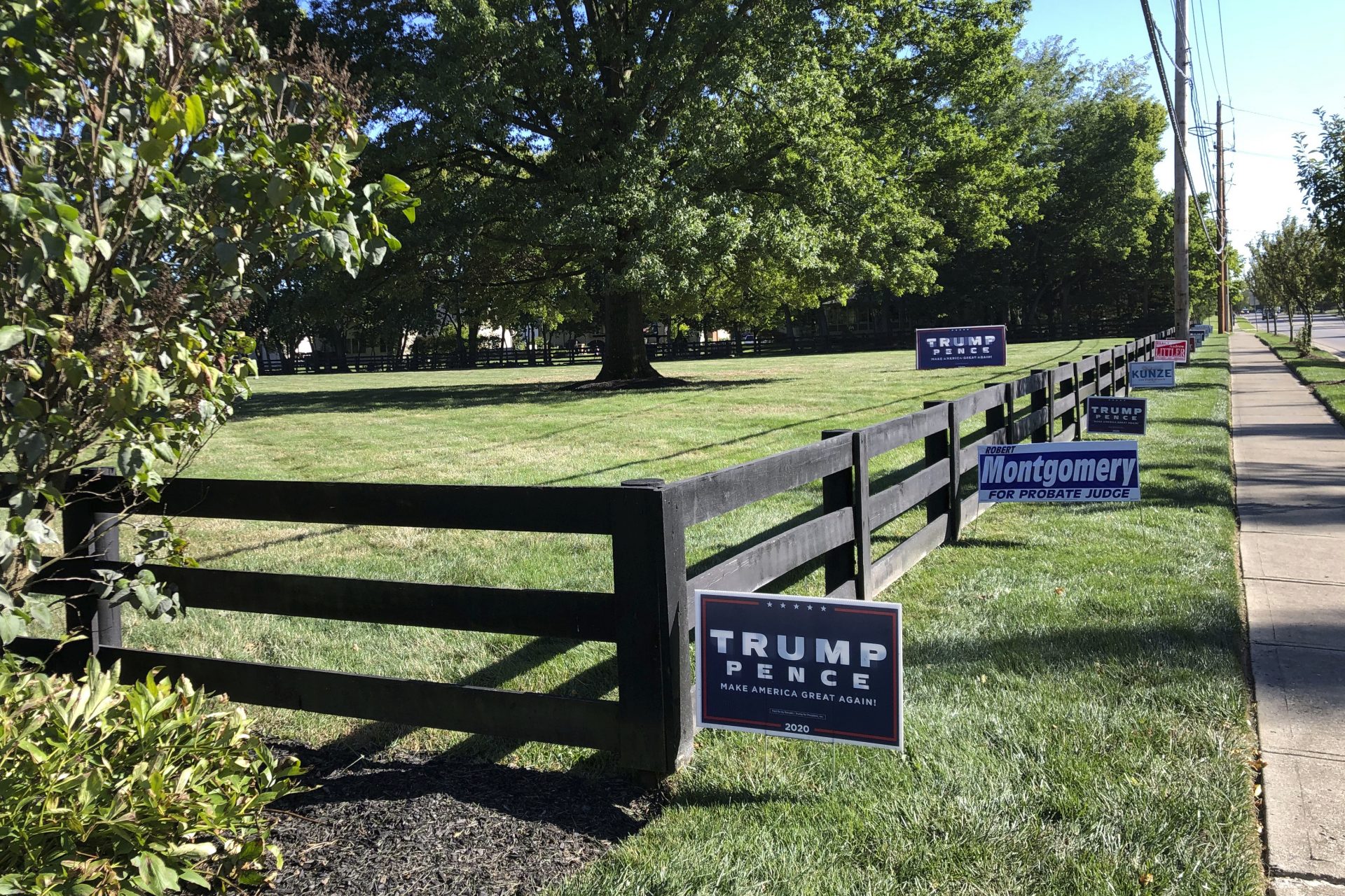 Signs in support of President Donald Trump and other Republican candidates on a lawn of a suburban Dublin, Ohio, home on Friday, Sept. 18, 2020