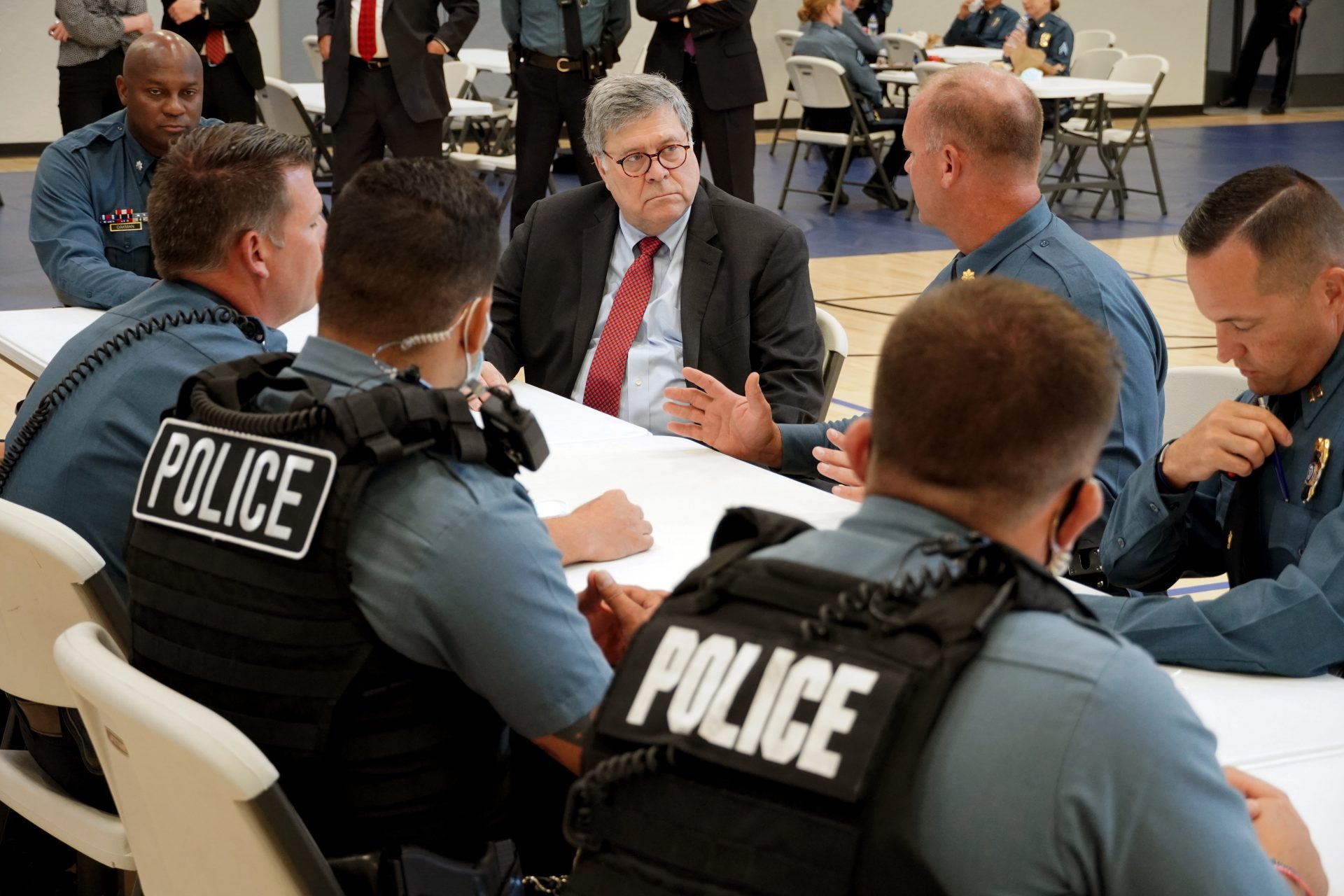 In this Aug. 19, 2020, photo Attorney General William Barr participates in a roll call with police officers from the Kansas City Police Department in Kansas City, Mo. In a private conference call this week with his U.S. attorneys nationwide, Attorney General William Barr said he wanted prosecutors to be aggressive in charging demonstrators who cause violence.