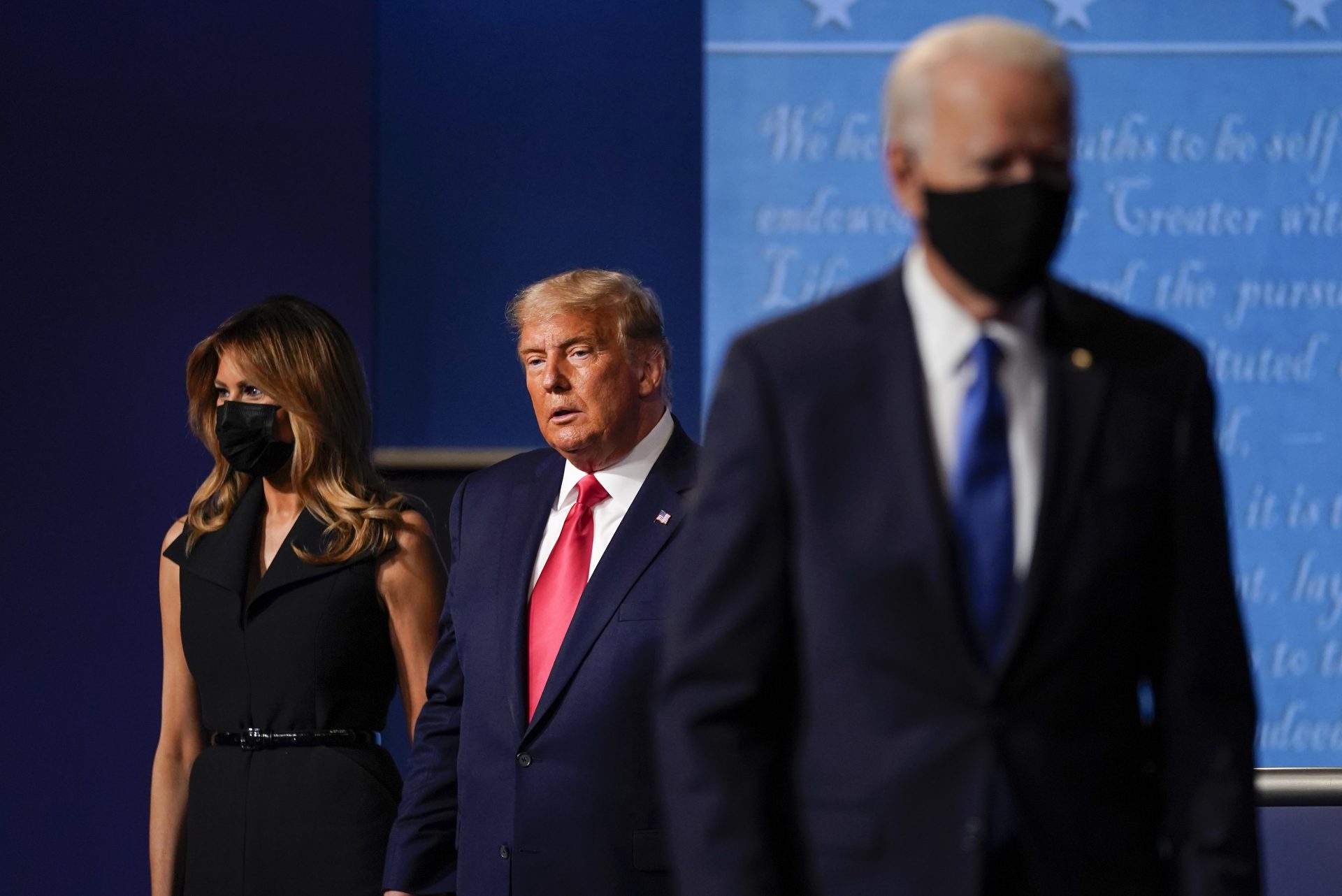 First lady Melania Trump, left, and President Donald Trump, center, remain on stage as Democratic presidential candidate former Vice President Joe Biden, right, walk away at the conclusion of the second and final presidential debate Thursday, Oct. 22, 2020, at Belmont University in Nashville, Tenn.