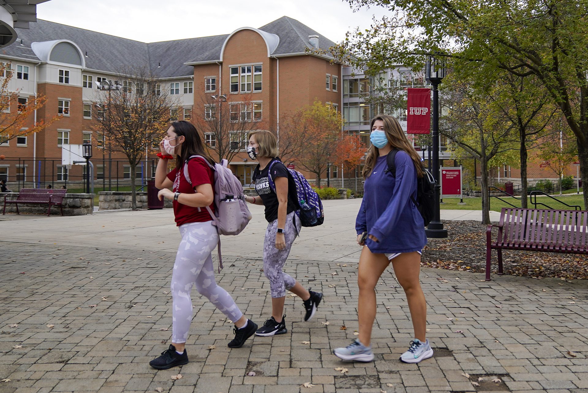 Students walk on the campus of Indiana University of Pennsylvania in Indiana, Pa, on Wednesday, Oct. 21, 2020.