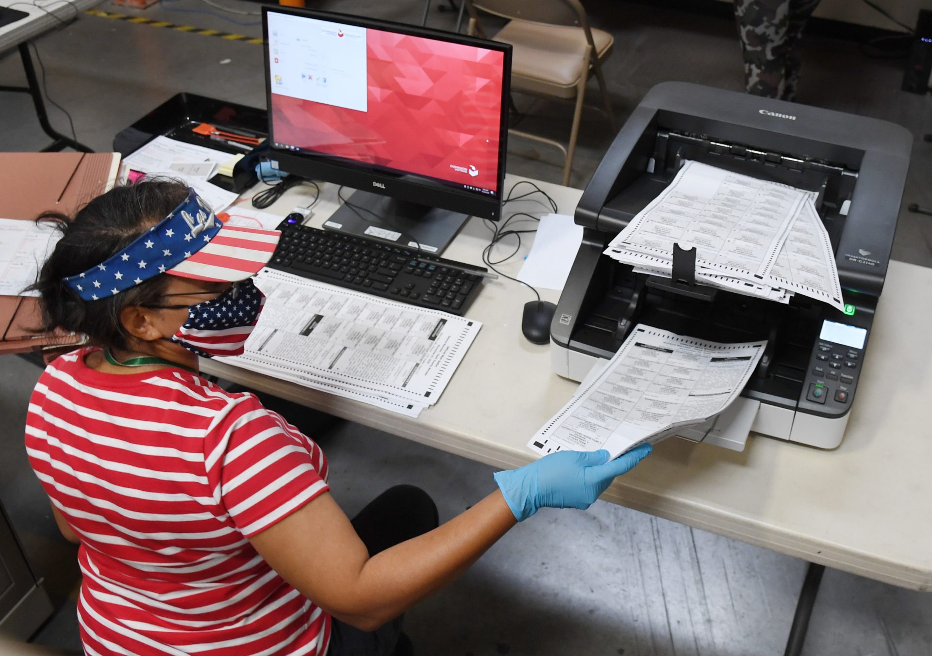 A Clark County, Nev. election worker scans mail-in ballots on October 20, 2020 in North Las Vegas. Nevada allows officials to count ballots received in advance of Election Day in order to speed the tabulation of results that evening.