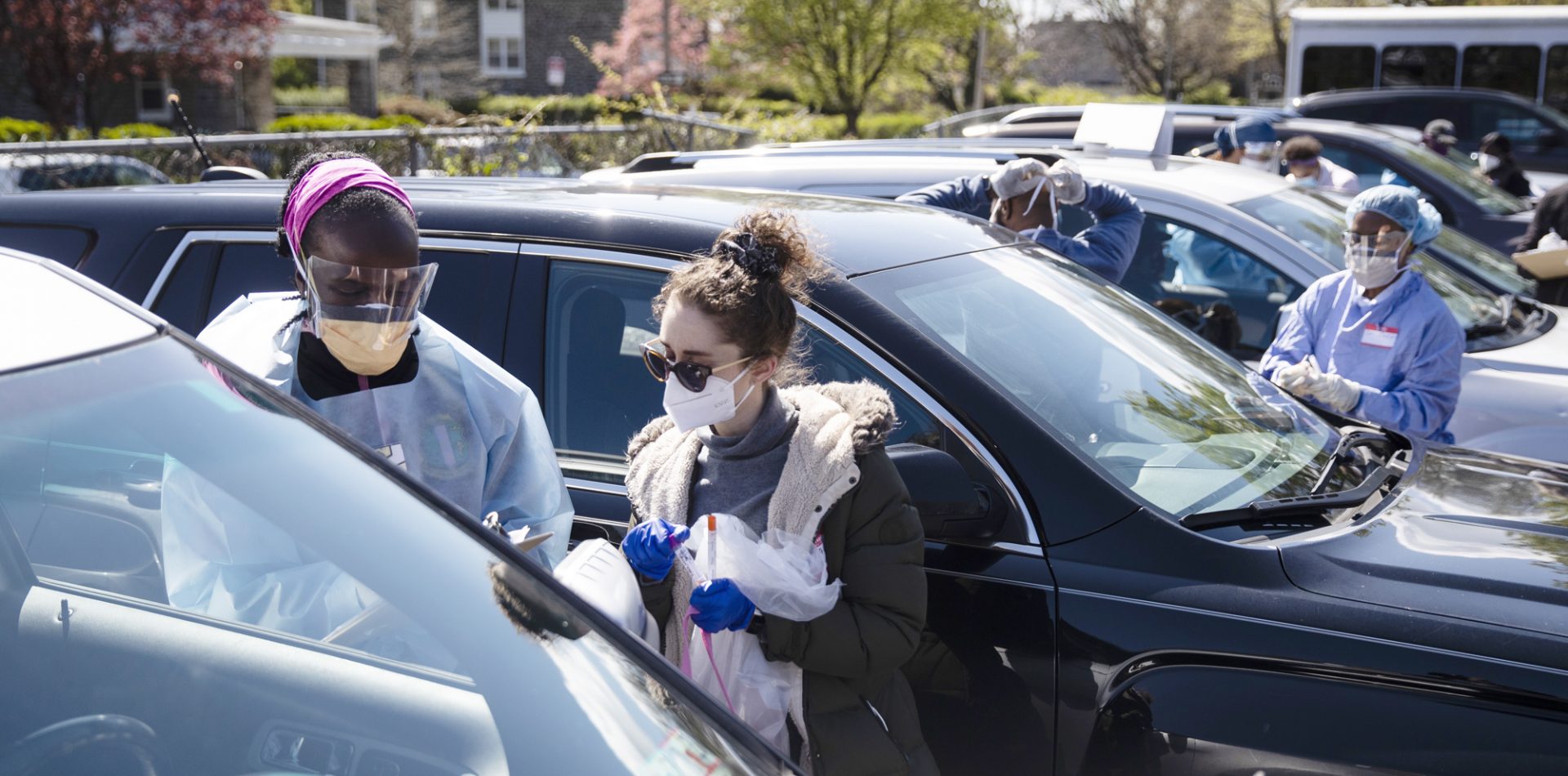 Stanford, left, assisted by medical student Tal Lee, prepares to administer a coronavirus swab test on a person in the parking lot of Pinn Memorial Baptist Church in Philadelphia on April 22.