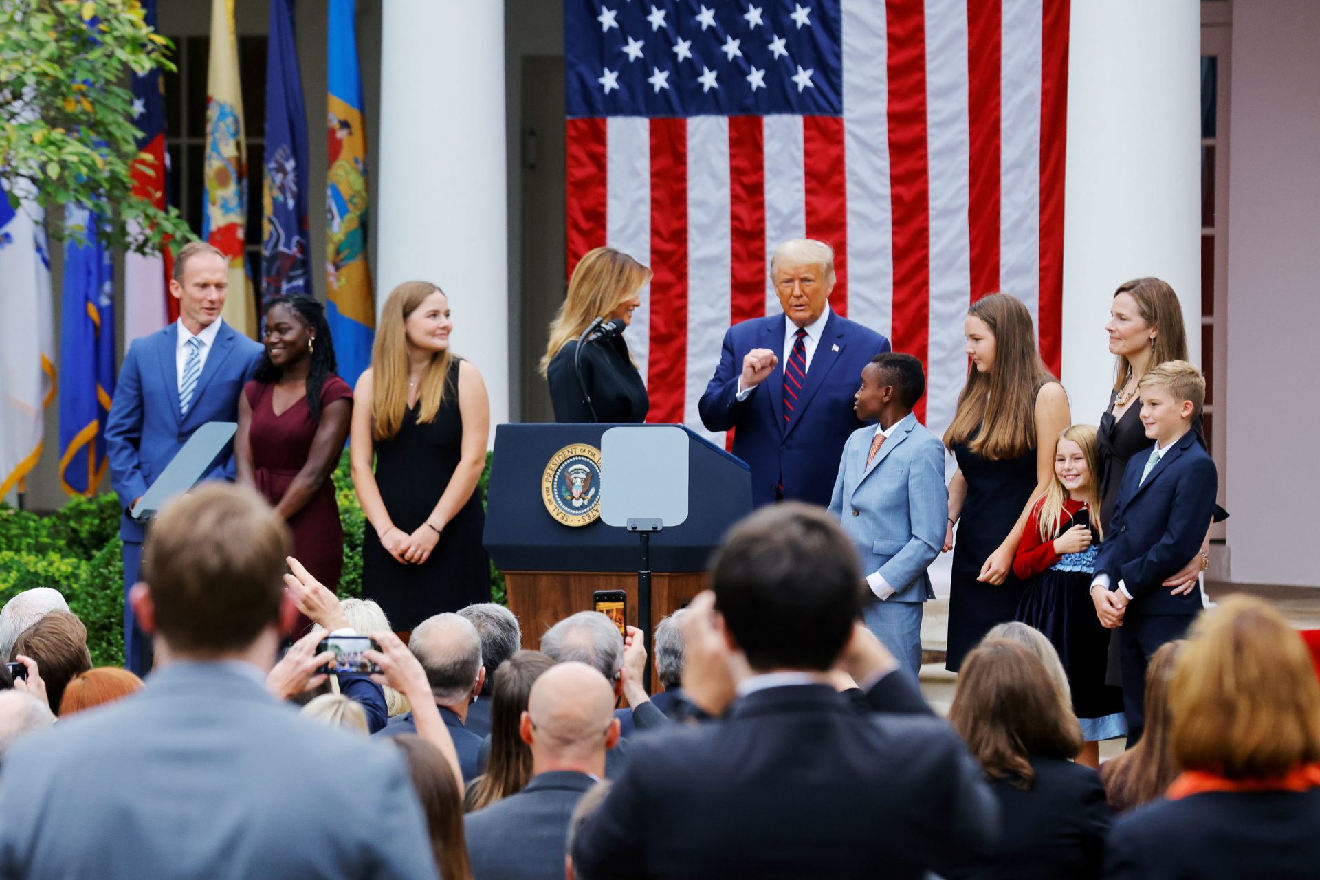 President Trump poses with Supreme Court nominee Amy Coney Barrett and her family at an event to announce her as his nominee on Saturday.