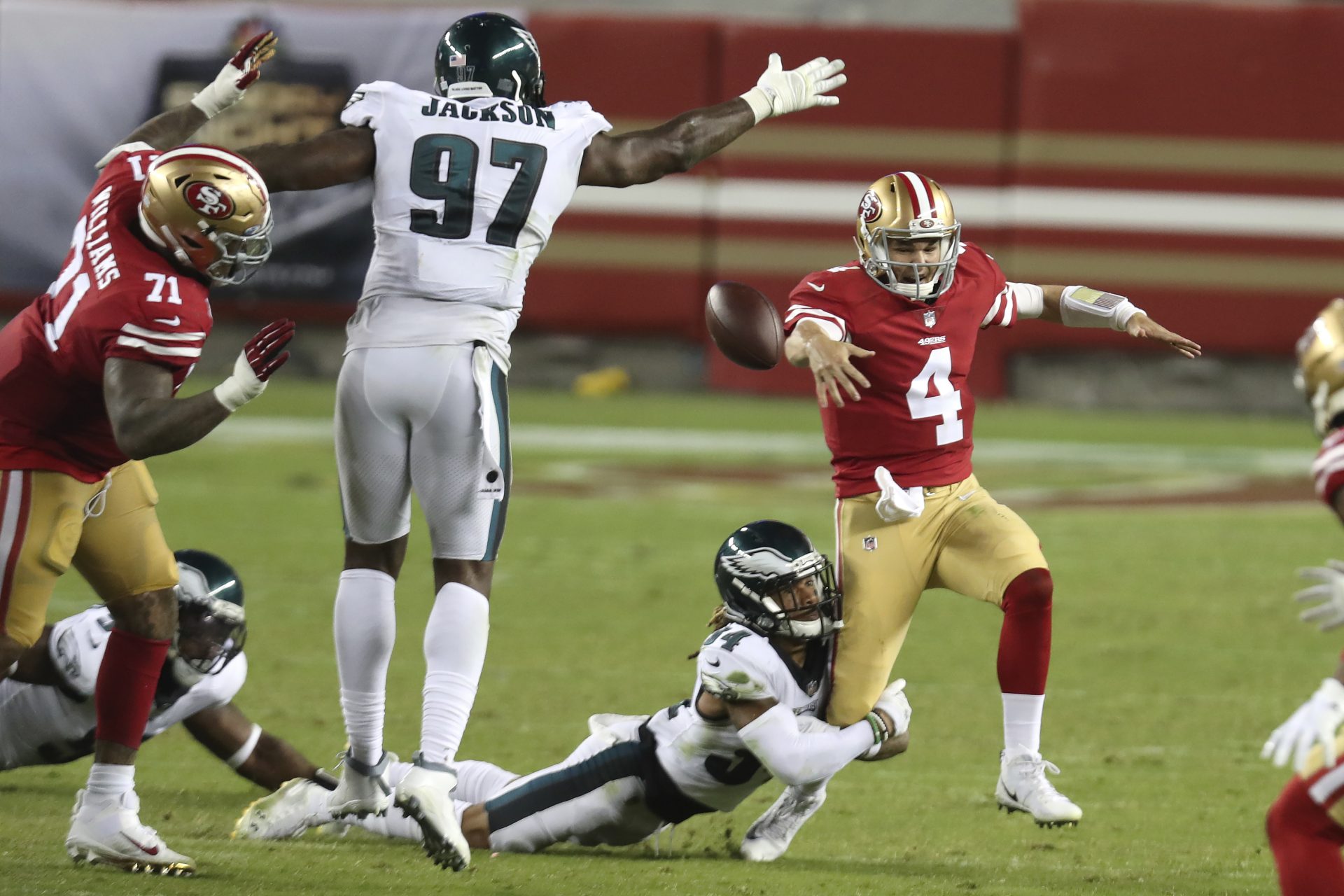 San Francisco 49ers quarterback Nick Mullens (4) fumbles the ball as he runs from Philadelphia Eagles cornerback Cre'von LeBlanc, bottom, which was recovered by defensive tackle Malik Jackson (97), during the second half of an NFL football game in Santa Clara, Calif., Sunday, Oct. 4, 2020.