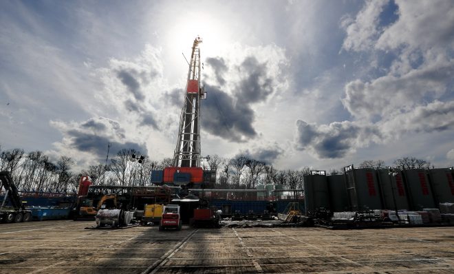 In this March 12, 2020, file photo, the sun shines through clouds above a shale gas drilling site in St. Mary's, Pa. 