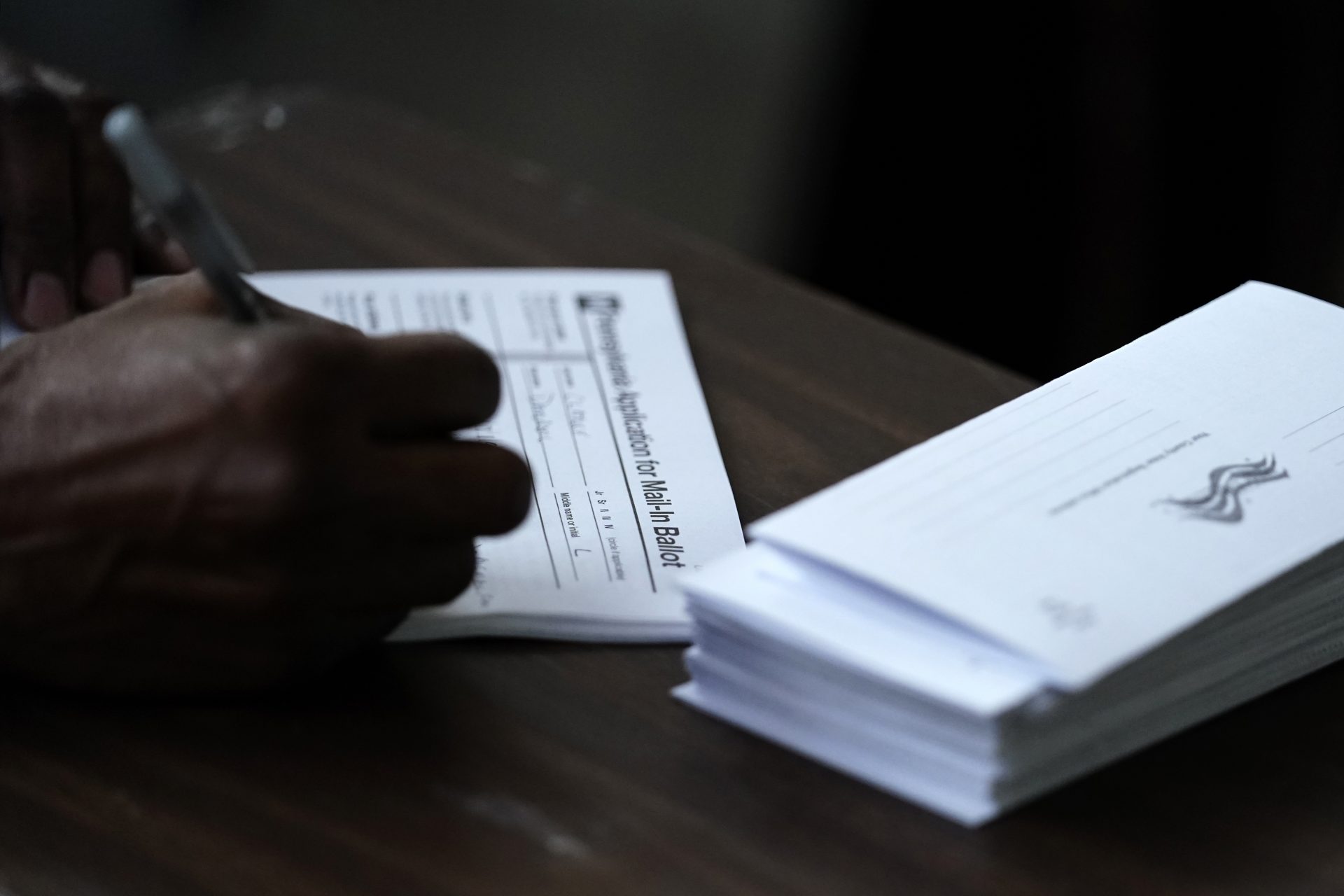  In this Sept. 29, 2020, file photo Philadelphia City Council President Darrell L. Clarke fills out an application for a mail-in ballot before voting at the opening of a satellite election office at Temple University's Liacouras Center in Philadelphia. Pennsylvania has seen a frenzy of election-related lawsuits as state officials prepare for some 3 million people, about half the expected turnout, to cast mail-in ballots.