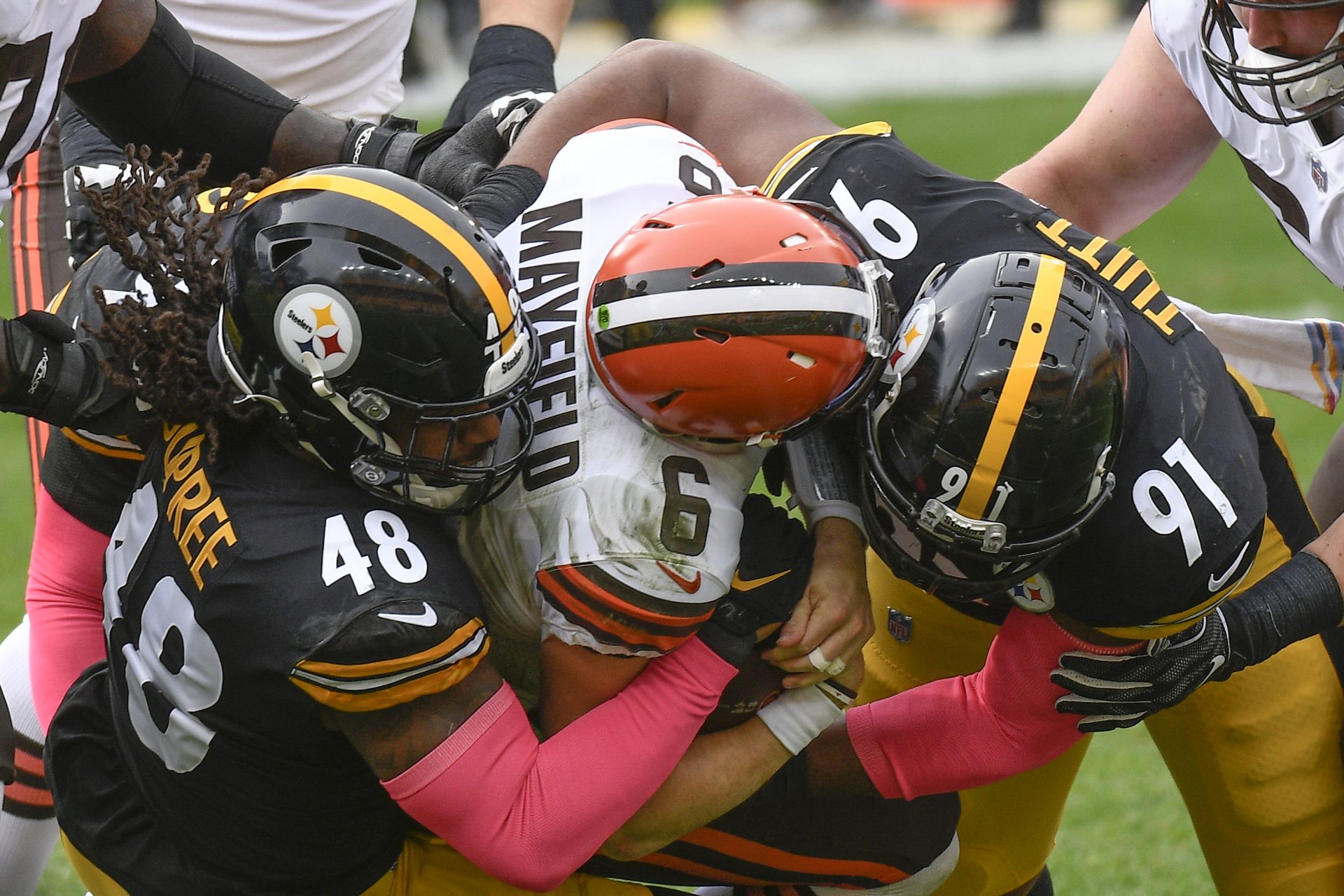 Cleveland Browns quarterback Baker Mayfield (6) is sacked by Pittsburgh Steelers defensive end Stephon Tuitt (91) and outside linebacker Bud Dupree (48) during the first half of an NFL football game, Sunday, Oct. 18, 2020, in Pittsburgh.