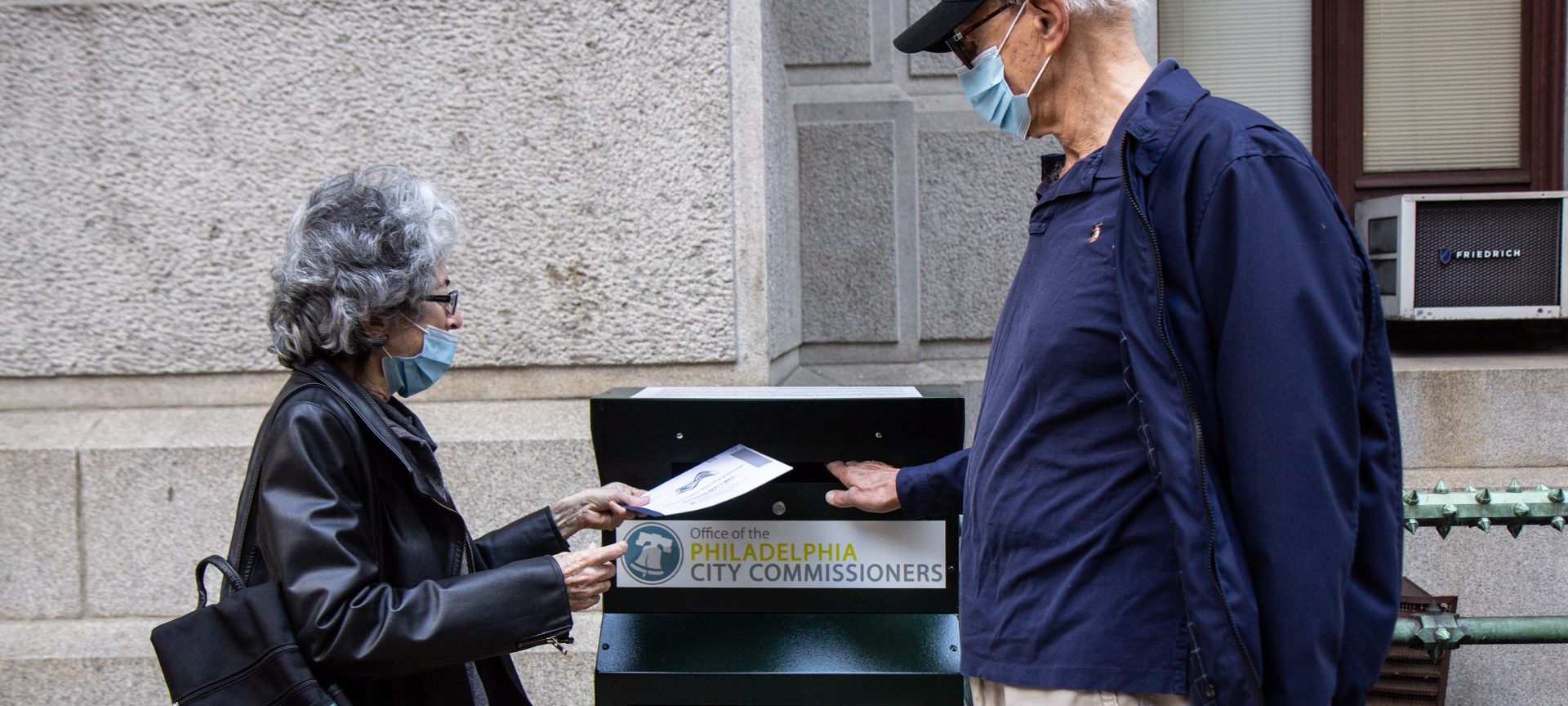 Alice and Len Sayles, Rittenhouse Square residents, return their ballots in the drop box outside City Hall in Philadelphia.