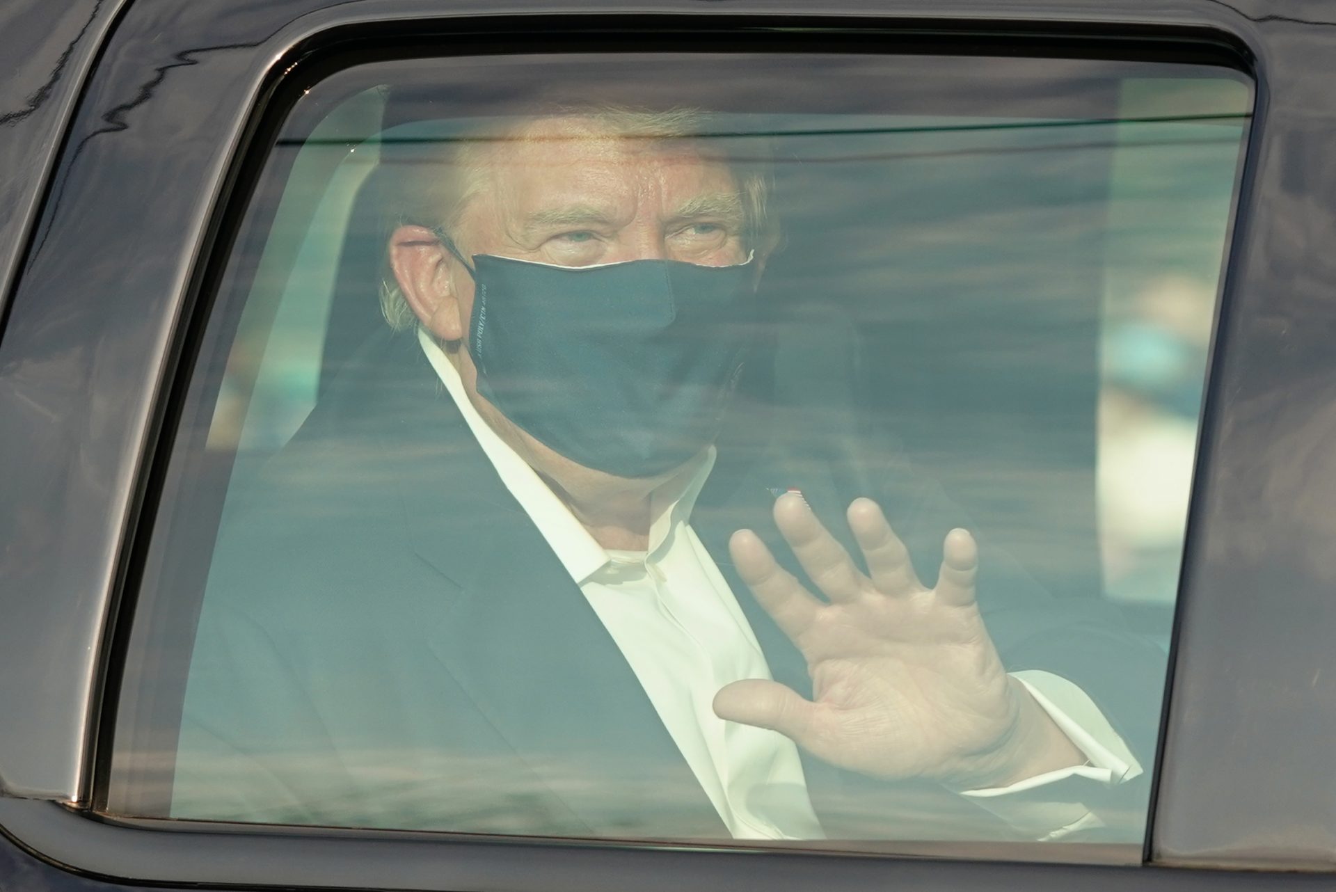 President Trump waves to supporters outside of Walter Reed National Military Medical Center in Bethesda, Md., on Sunday.