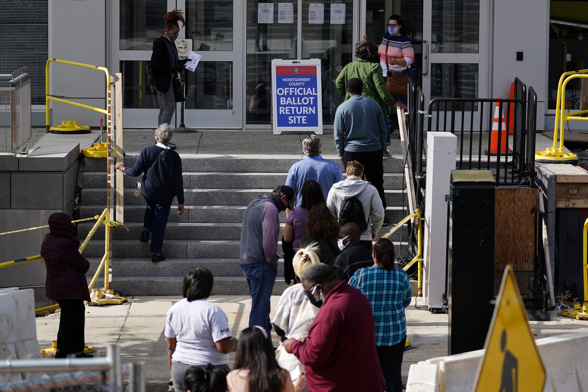 Residents line up outside the Montgomery County, Pa., Voter Services office, Monday, Oct. 19, 2020, in Norristown, Pa.
