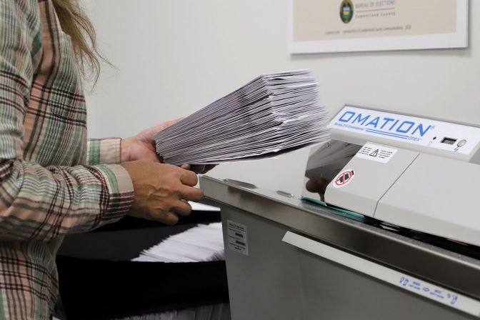 A worker processes mail-in ballots at the Cumberland County Bureau of Elections on Nov. 4, 2020.