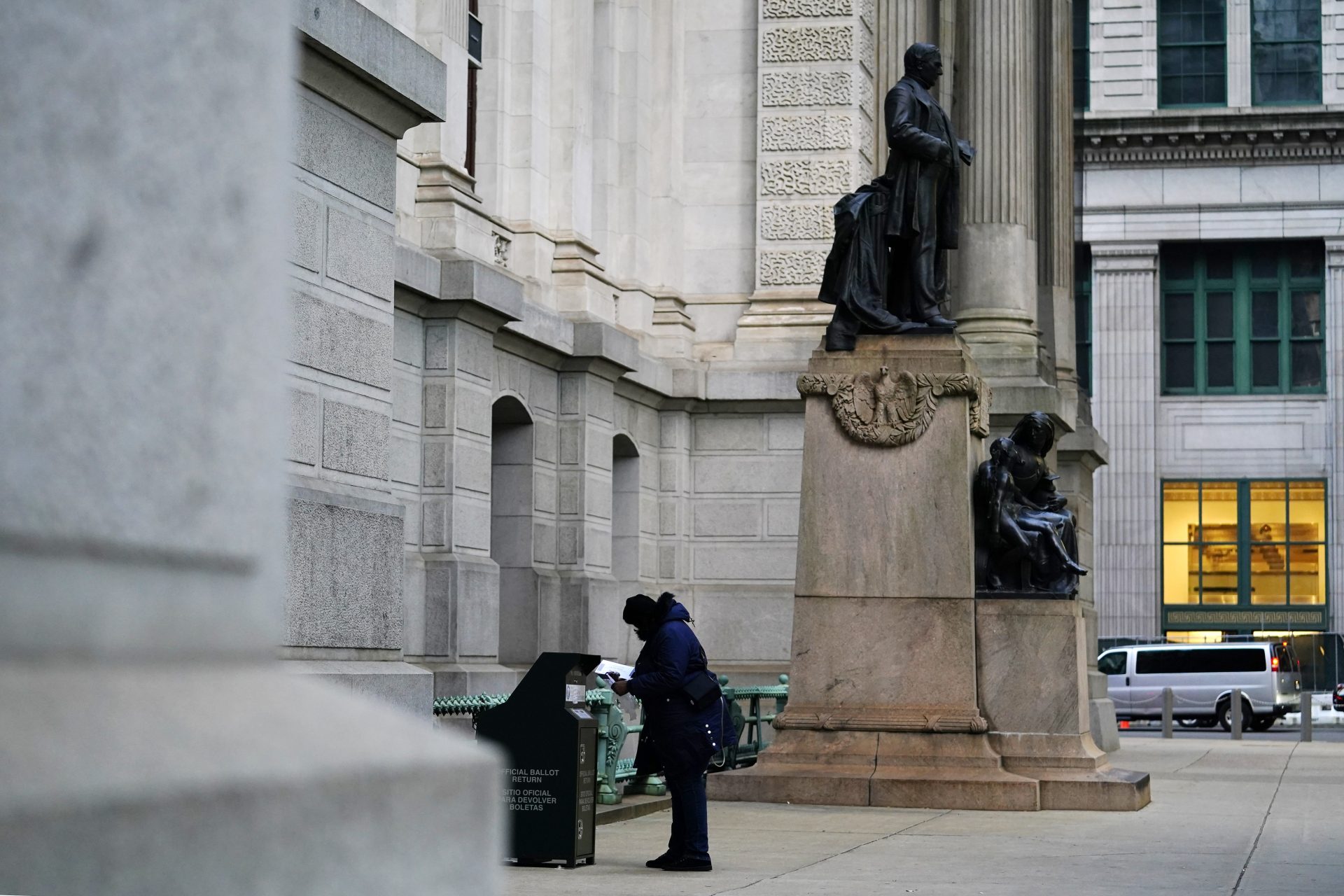 A woman drops off a ballot for the 2020 General Election in the United States outside City Hall, Monday, Nov. 2, 2020, in Philadelphia.