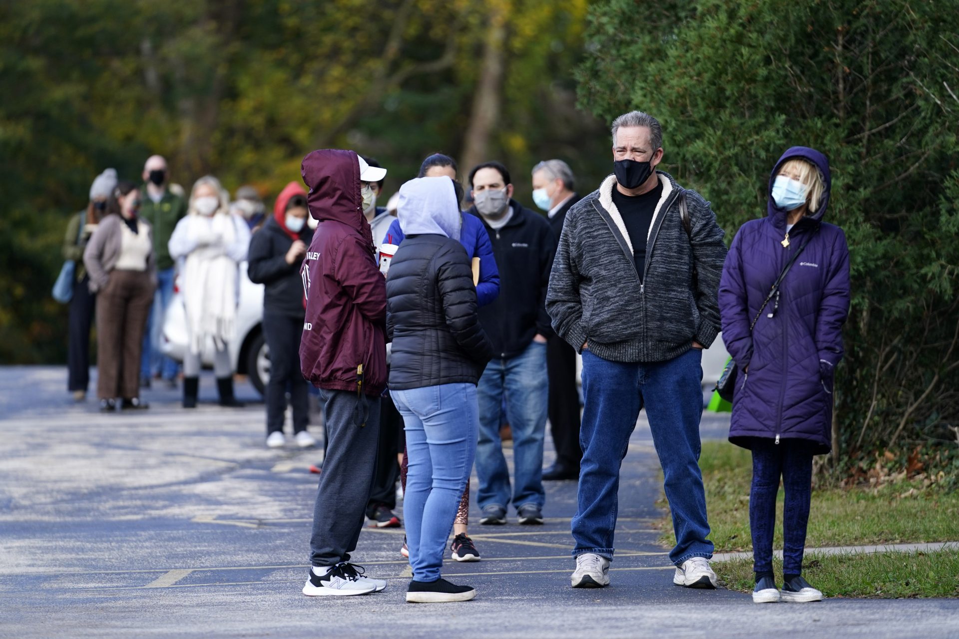 People wait outside a polling place to cast their ballots in the 2020 on Election Day, Tuesday, Nov. 3, 2020, in Media, Pa.