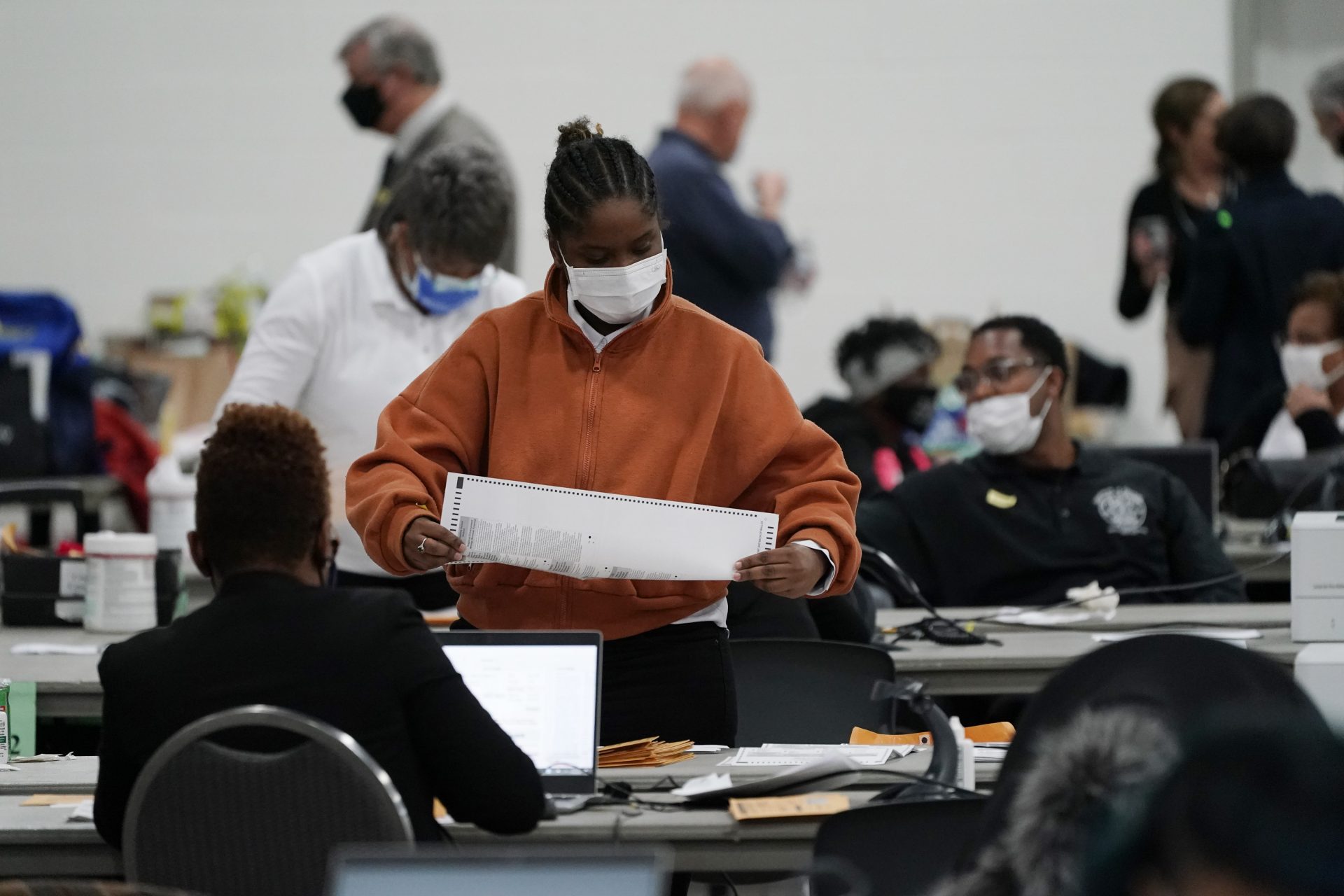 Absentee ballots are processed at the central counting board, Wednesday, Nov. 4, 2020, in Detroit. The fate of the United States presidency hung in the balance Wednesday morning, as President Donald Trump and Democratic challenger Joe Biden battled for three familiar battleground states, Wisconsin, Michigan and Pennsylvania, that could prove crucial in determining who wins the White House.
