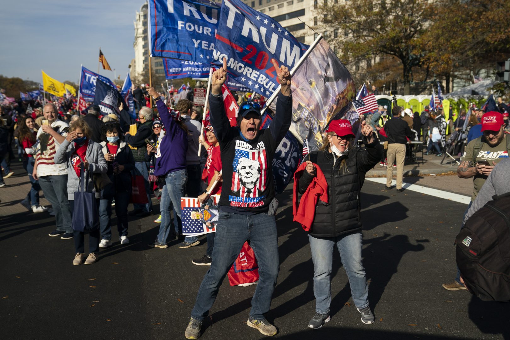Supporters of President Donald Trump cheer as his motorcade drives past a rally of supporters near the White House, Saturday, Nov. 14, 2020, in Washington. 