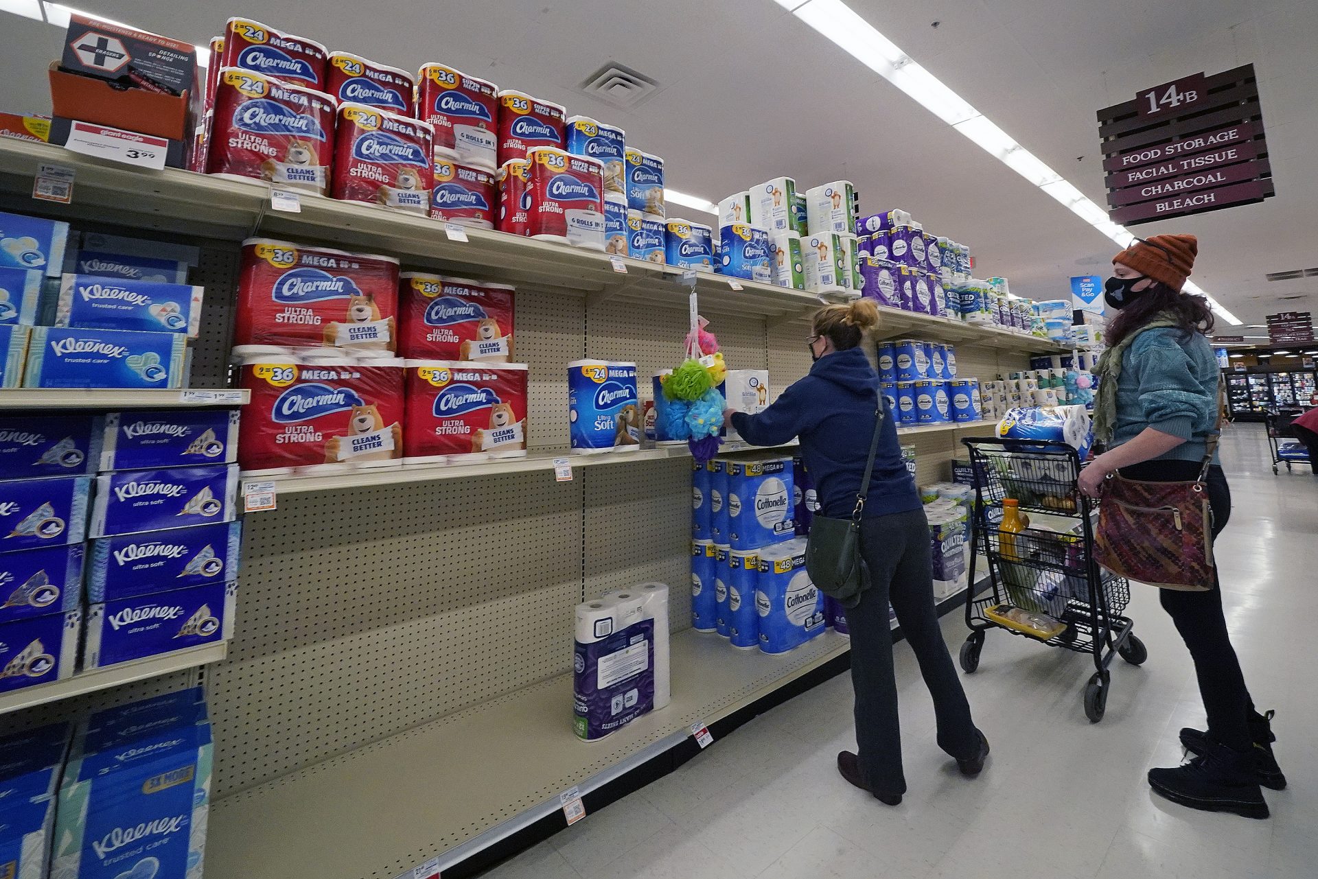 A woman buys toilet paper at a market in Mount Lebanon, Pa, on Tuesday, Nov. 17, 2020. Pennsylvania is strengthening its mask mandate and will require out-of-state travelers to test negative for the coronavirus before arrival. The state health secretary, Dr. Rachel Levine, said the new measures are in response to a sharp increase in infections and hospitalizations. She said Tuesday that masks are now required indoors wherever people from different households are gathered — even if they are physically distant. Like the rest of the nation, Pennsylvania has seen coronavirus infections explode in recent weeks.