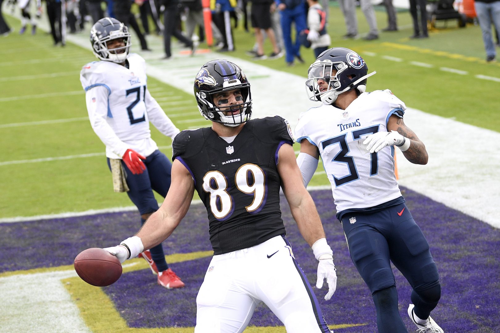 Baltimore Ravens tight end Mark Andrews (89) reacts after scoring on a touchdown pass from quarterback Lamar Jackson, not visible, during the second half of an NFL football game against the Tennessee Titans, Sunday, Nov. 22, 2020, in Baltimore. Titans' Amani Hooker (37) and Malcolm Butler (21) look on. (AP Photo/Nick Wass)