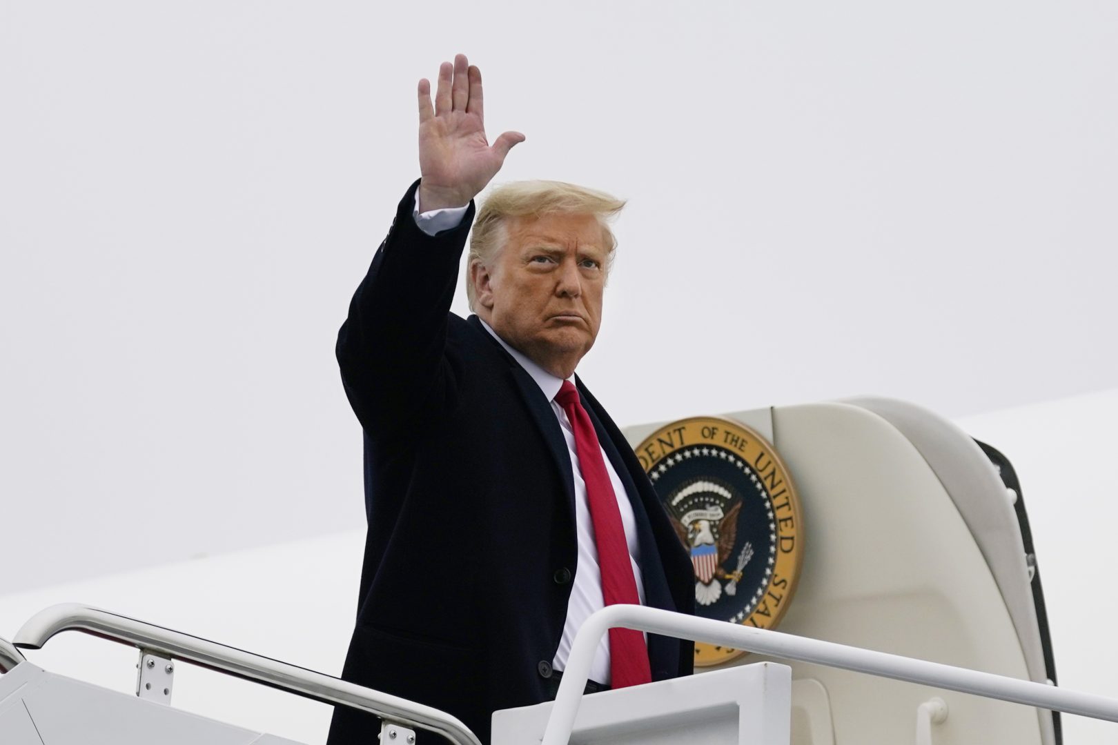 President Donald Trump waves as he boards Air Force One upon departure Monday, Oct. 26, 2020, at Andrews Air Force Base, Md., as he heads to Pennsylvania for campaign rallies.