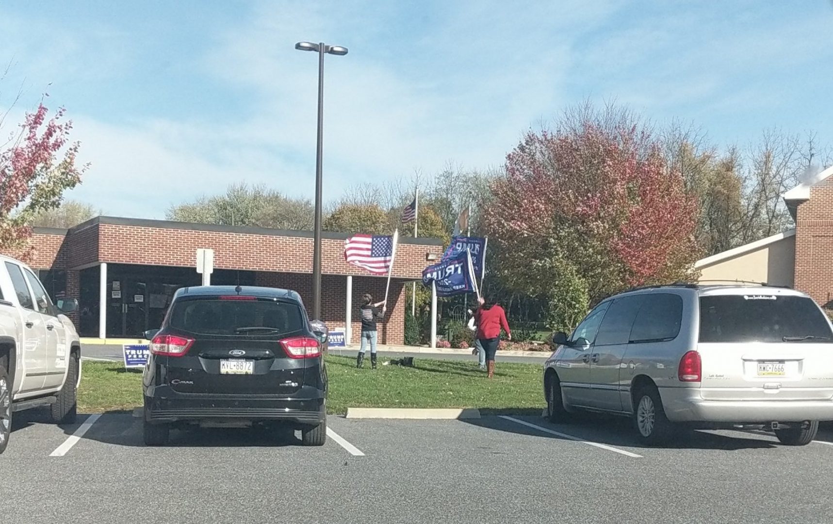 Three people showed support for President Donald Trump by playing music and recordings of his voice in the parking lot of a polling place at Sacred Heart Parish Center in Cornwall, Lebanon County, on Nov. 3, 2020.