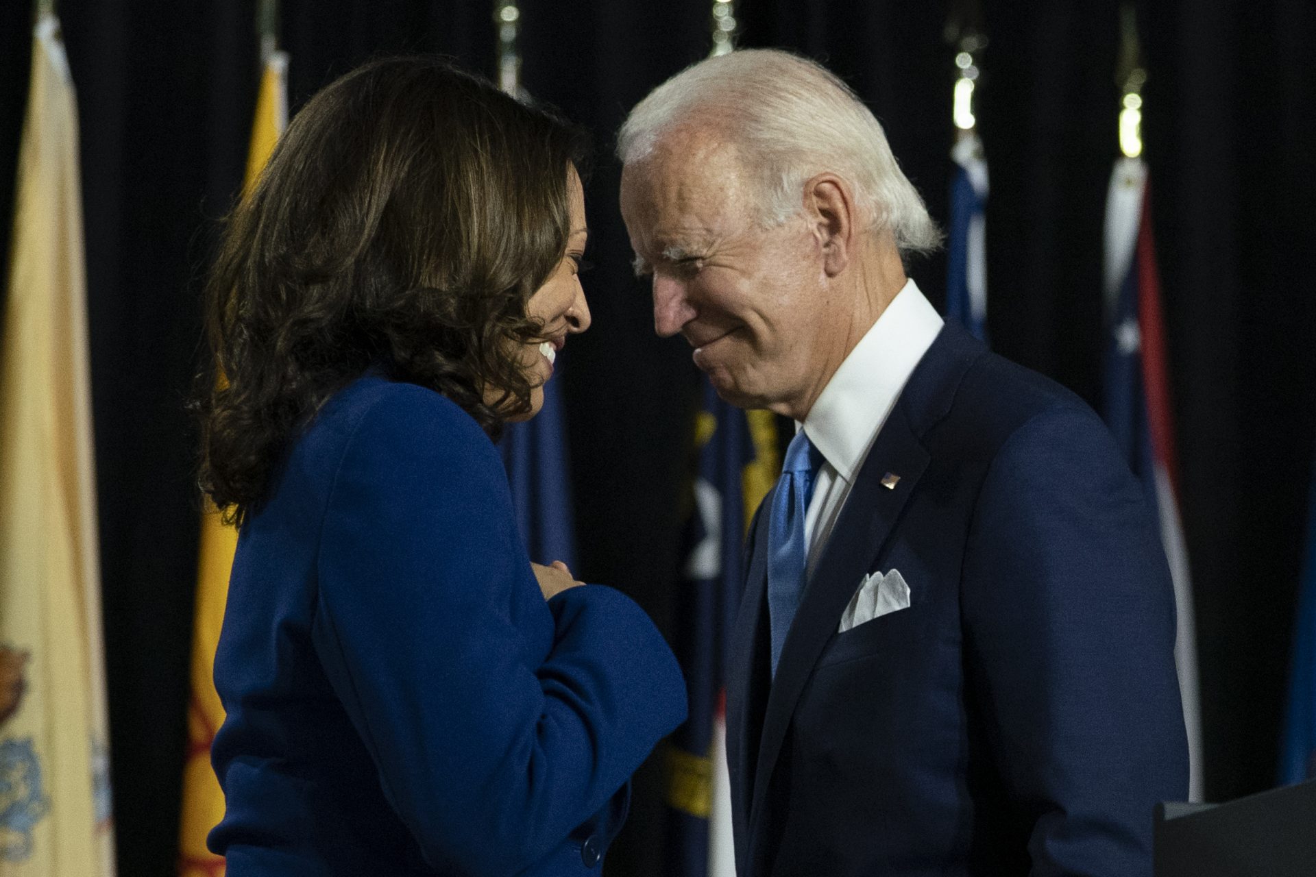 In this Aug. 12, 2020, file photo, Democratic presidential candidate former Vice President Joe Biden and his running mate Sen. Kamala Harris, D-Calif., pass each other as Harris moves to the podium to speak during a campaign event at Alexis Dupont High School in Wilmington, Del. Harris made history Saturday, Nov. 7, as the first Black woman elected as vice president of the United States, shattering barriers that have kept men — almost all of them white — entrenched at the highest levels of American politics for more than two centuries.