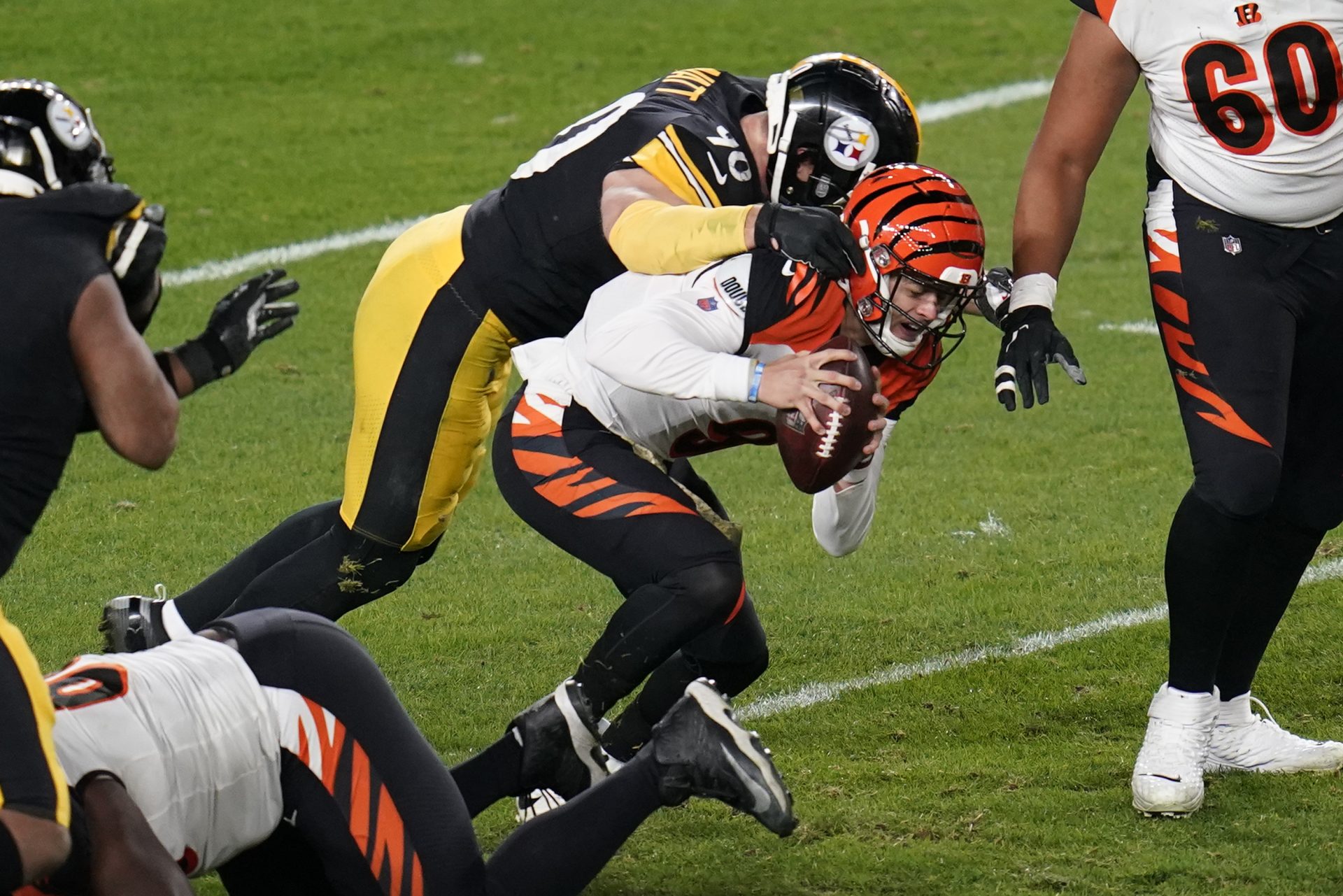 Cincinnati Bengals quarterback Joe Burrow (9) is sacked by Pittsburgh Steelers outside linebacker T.J. Watt (90) during the first half of an NFL football game, Sunday, Nov. 15, 2020, in Pittsburgh.