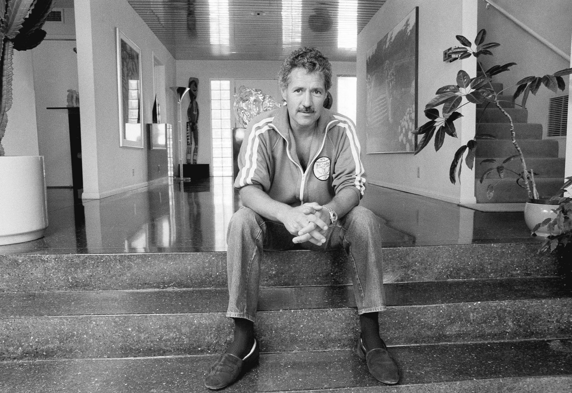 Game show host Alex Trebek poses for a photo in his Los Angeles home on Aug. 3, 1988. Trebek, who presided over the beloved quiz show “Jeopardy!” for more than 30 years with dapper charm and a touch of school-master strictness, died Sunday, Nov. 8, 2020. He was 80.