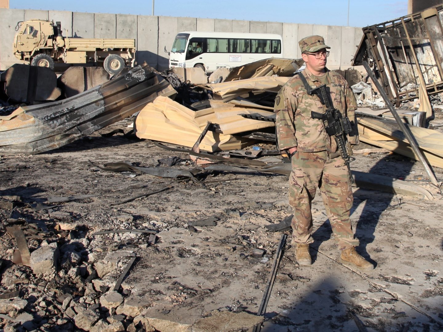 In this Monday, Jan. 13, 2020 photo, A U.S. Soldier stands at the spot hit by Iranian bombing at Ain al-Asad air base, in Anbar, Iraq. Ain al-Asad air base was struck by a barrage of Iranian missiles on Wednesday, in retaliation for the U.S. drone strike that killed atop Iranian commander, Gen. Qassem Soleimani, whose killing raised fears of a wider war in the Middle East.