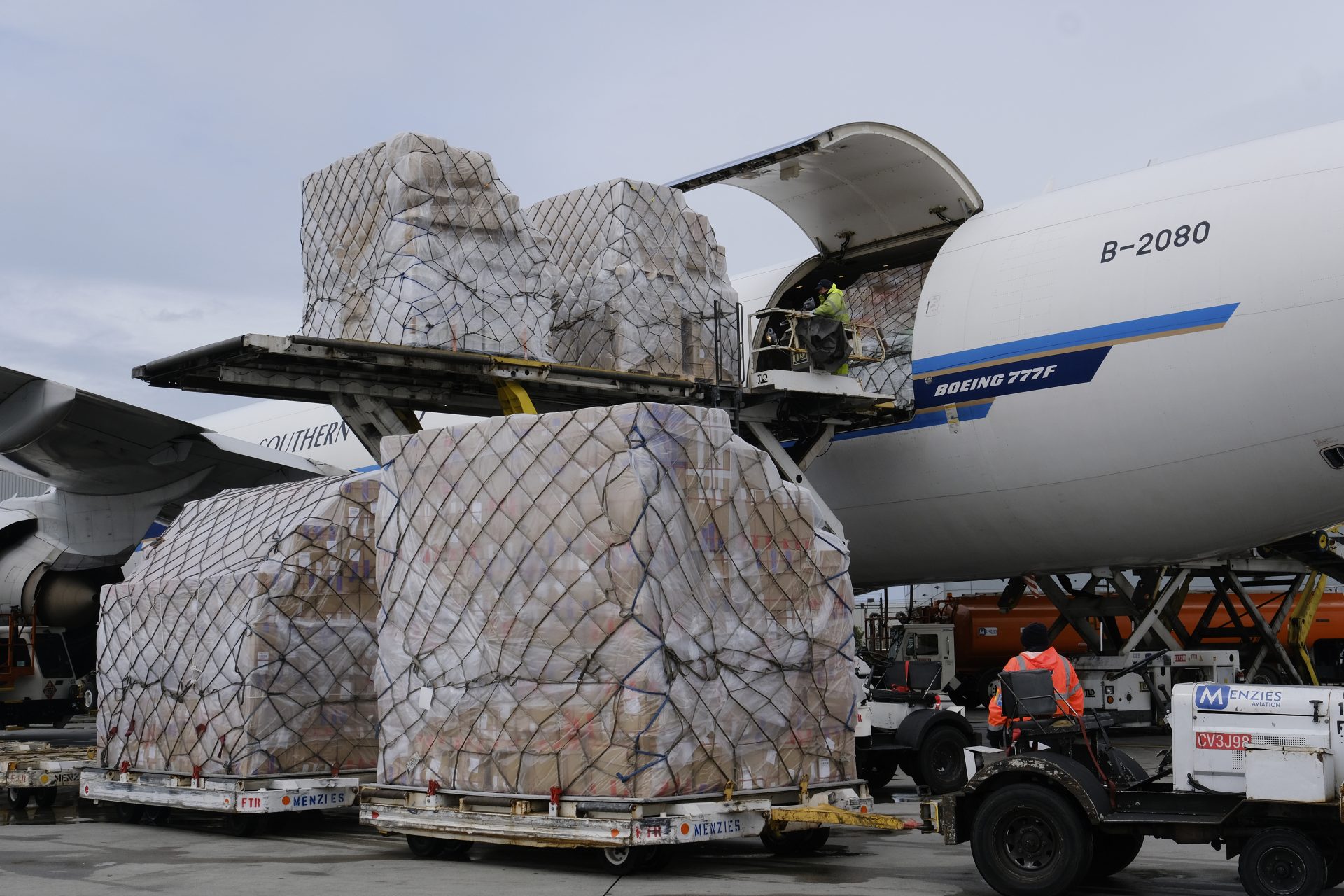 Ground crew at the Los Angeles International airport unload pallets of supplies of medical personal protective equipment from a China Southern Cargo plane upon its arrival on April 10, 2020.