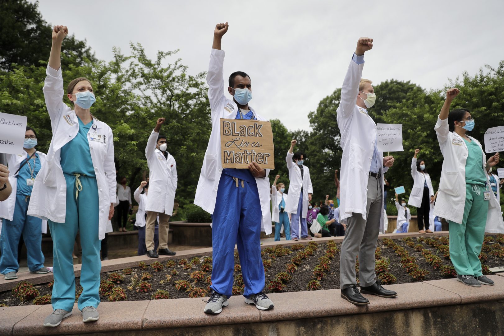 Healthcare professionals gather outside Barnes-Jewish Hospital to demonstrate in support of the Black Lives Matter movement Friday, June 5, 2020, in St. Louis, Mo. The White Coats for Black Lives protest was organized to stand in solidarity with those speaking out against the death of George Floyd who died after being restrained by Minneapolis police officers on May 25.