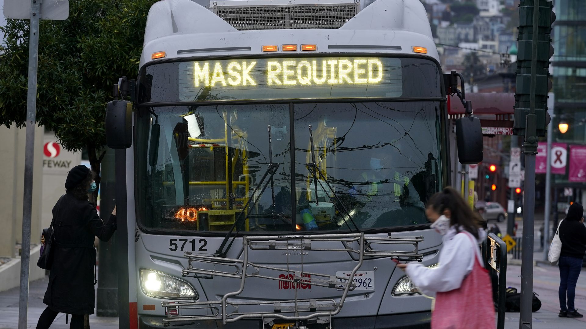 A sign on a San Francisco bus advises that passengers are required to wear masks. Health officials have renewed pleas for Americans to protect themselves and others from the coronavirus as the death toll passes 250,000.