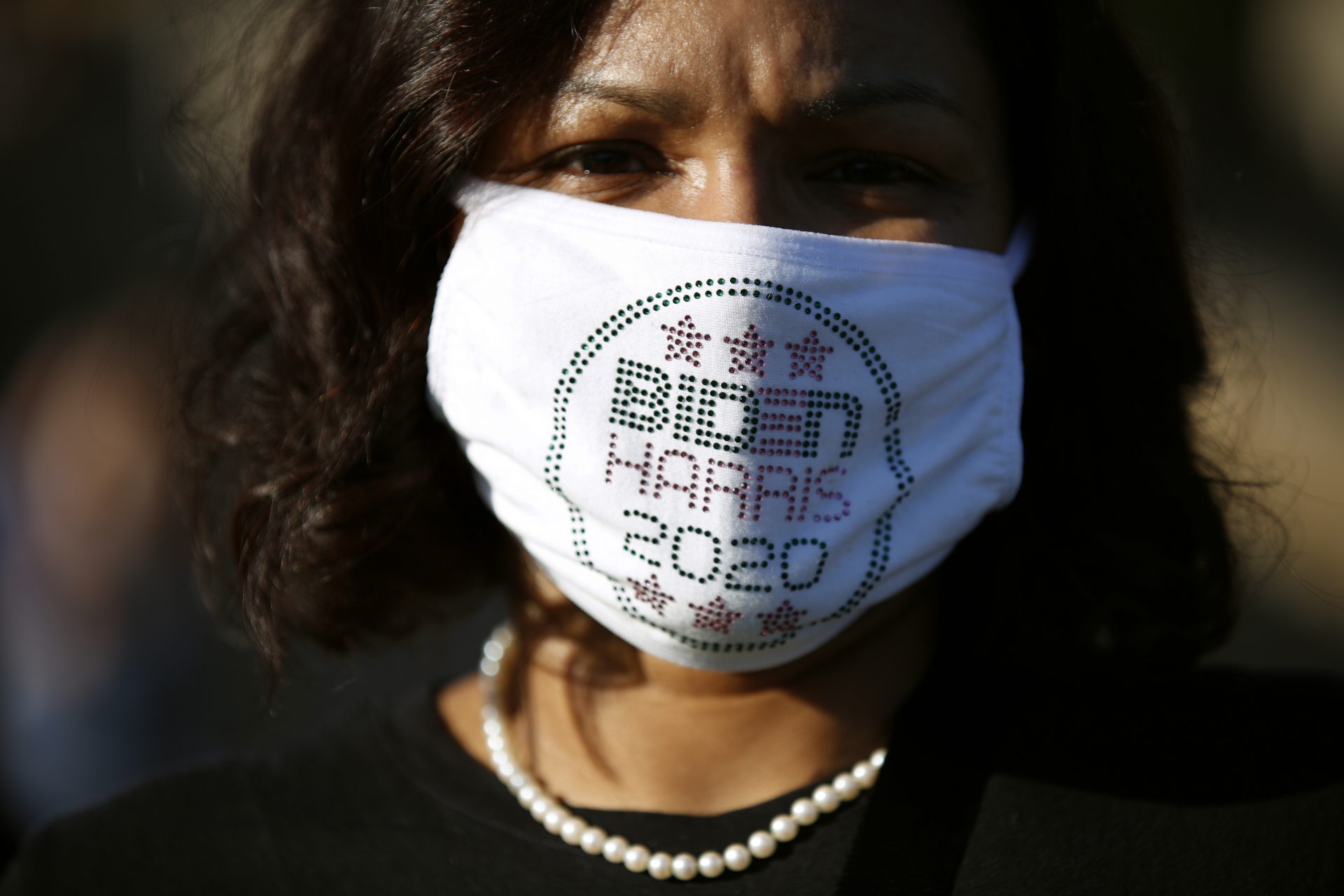 Candice Richardson, a native of Trinidad who grew up in New York and lives in Philadelphia, wears a protective mask supporting President-elect Joe Biden and Vice President-elect Kamala Harris during a celebration outside the Philadelphia Museum of Art, Sunday, Nov. 8, 2020, in Philadelphia.