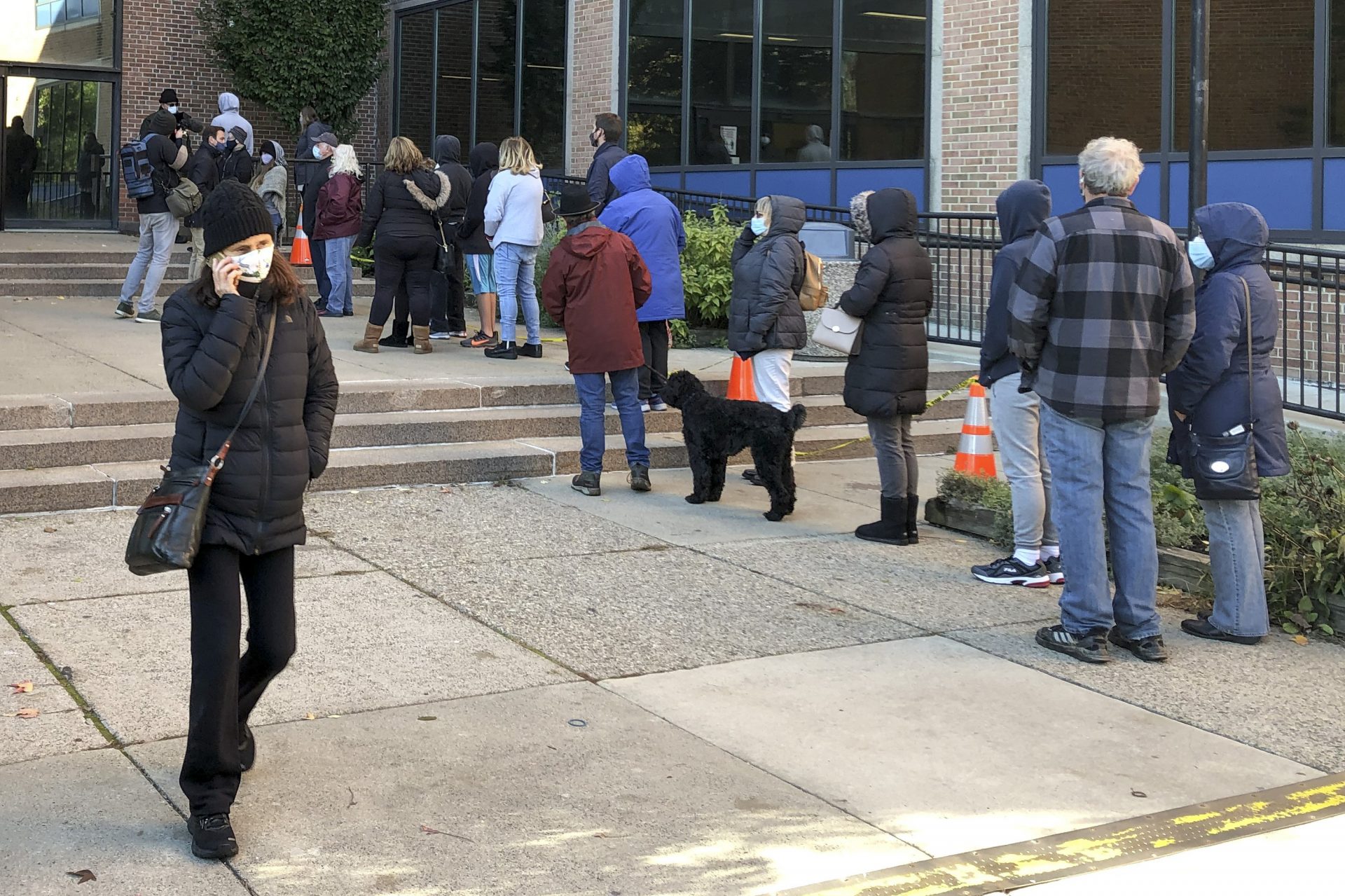 Voters wait in line outside the Bucks county government building in Doylestown, Pa., a suburb of Philadelphia, on Monday, Nov. 2, 2020. Some said they received word that their mail-in ballots had problems and needed to be fixed in order to count.