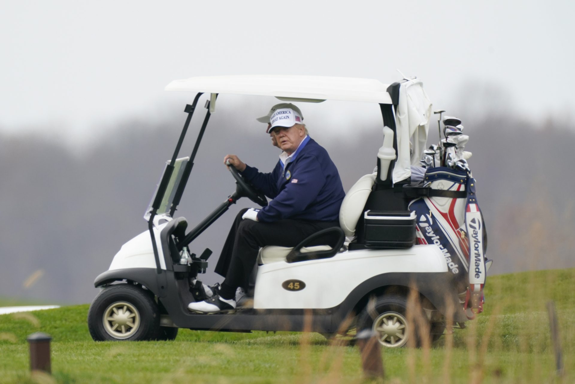 President Donald Trump drives a golf cart as he golfs at Trump National Golf Club in Sterling, Va., Sunday, Nov. 22, 2020.