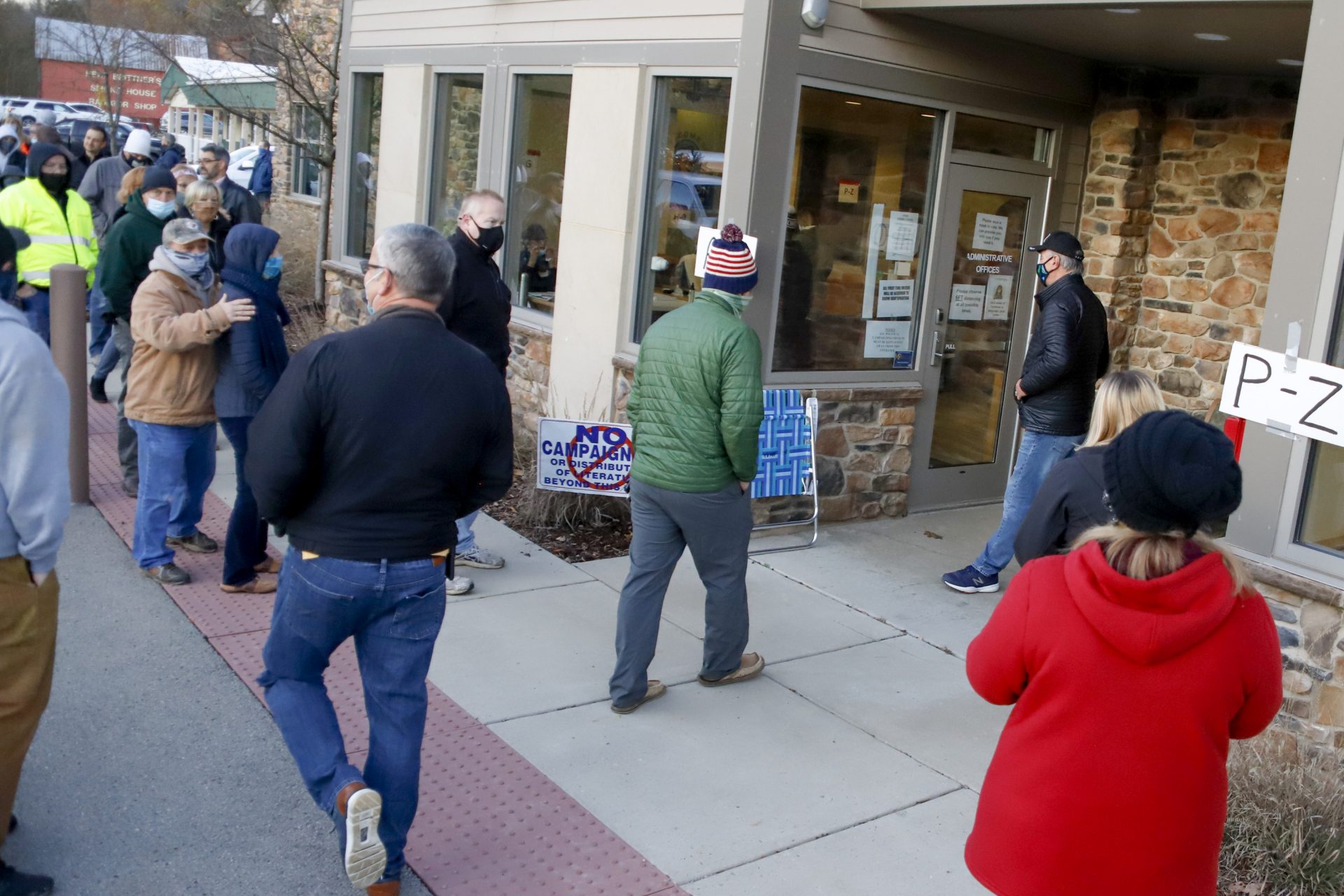 People lined up at the Jackson Township Municipal Building, start to enter the poll as it opens, Tuesday, Nov. 3, 2020, Election Day, in Jackson Township, Pa.