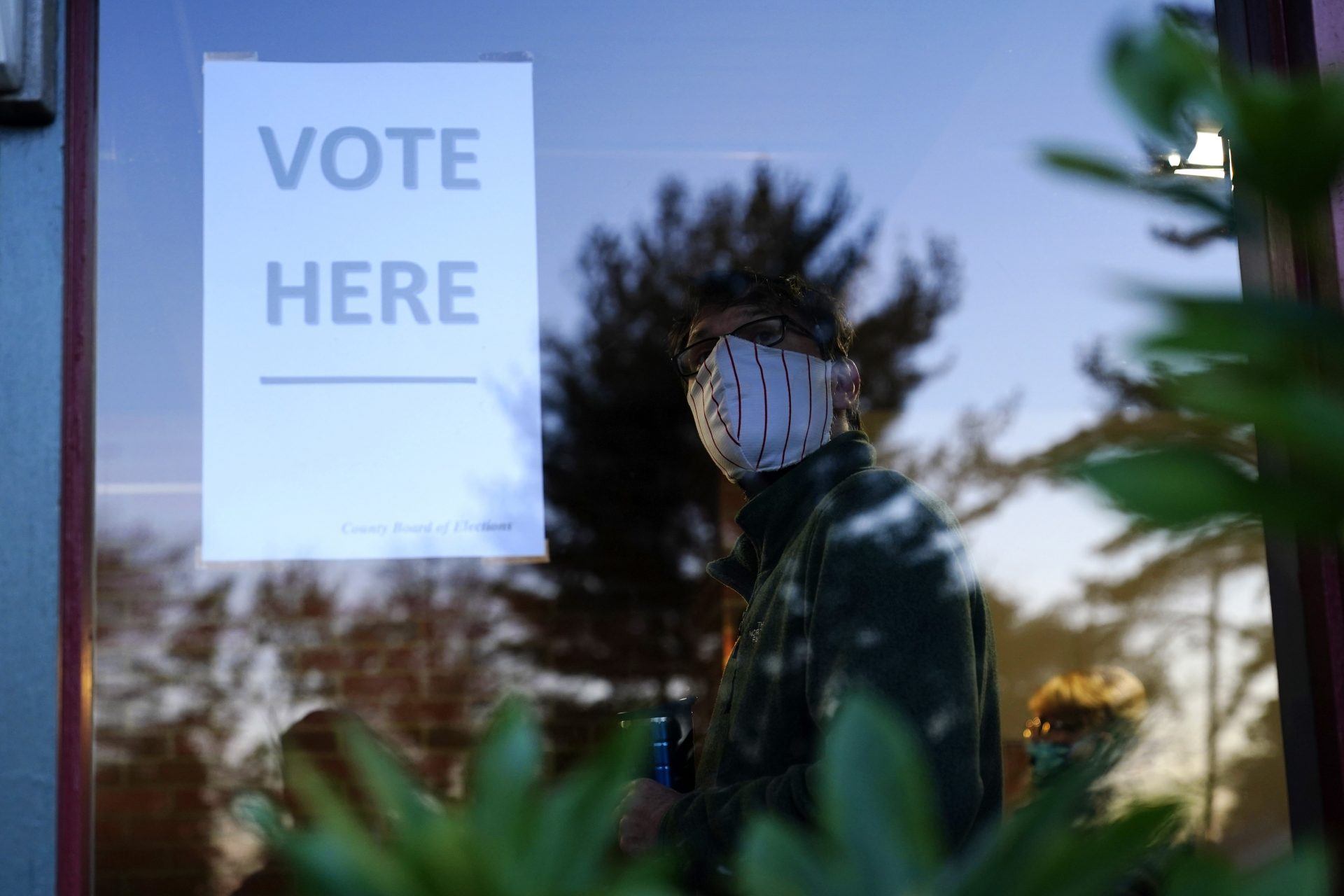 A voter lines up in a polling place to cast a ballot for the 2020 general election in the United States, Tuesday, Nov. 3, 2020, in Springfield, Pa.