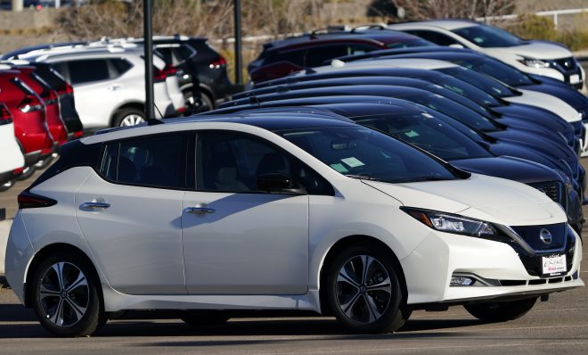 A long line of unsold 2021 Leaf electric vehicles sits at a Nissan dealership Sunday, Nov. 8, 2020, in Highlands Ranch, Colo. 